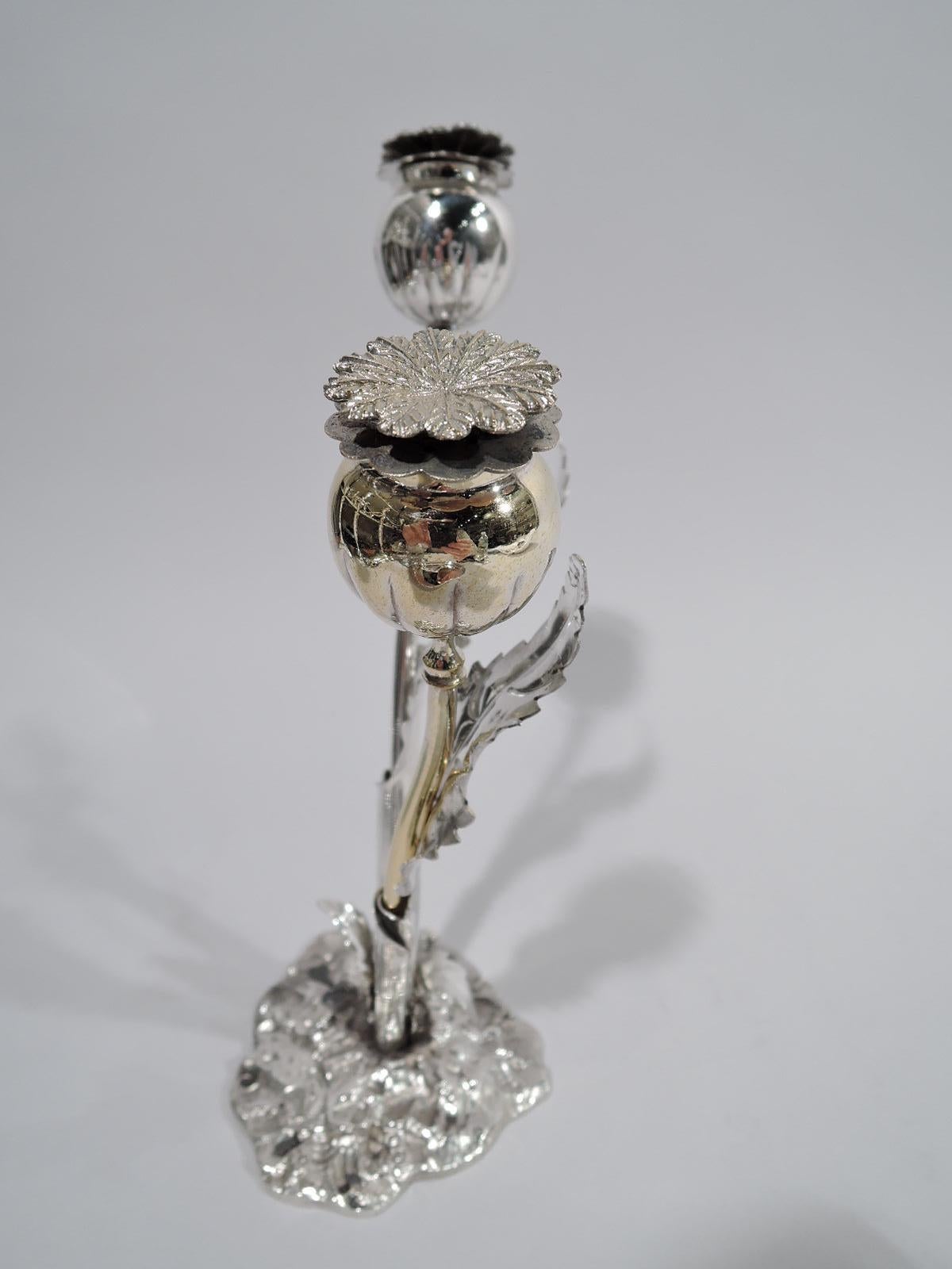 Stylish sterling silver figural salt and pepper shakers. Two flowers (one gilt) set in stand. Each flower has a curvilinear stem, round bud with threaded double-leaf cover (bottom leaf pierced). Stand has two holders in form of wrapped leaves rooted