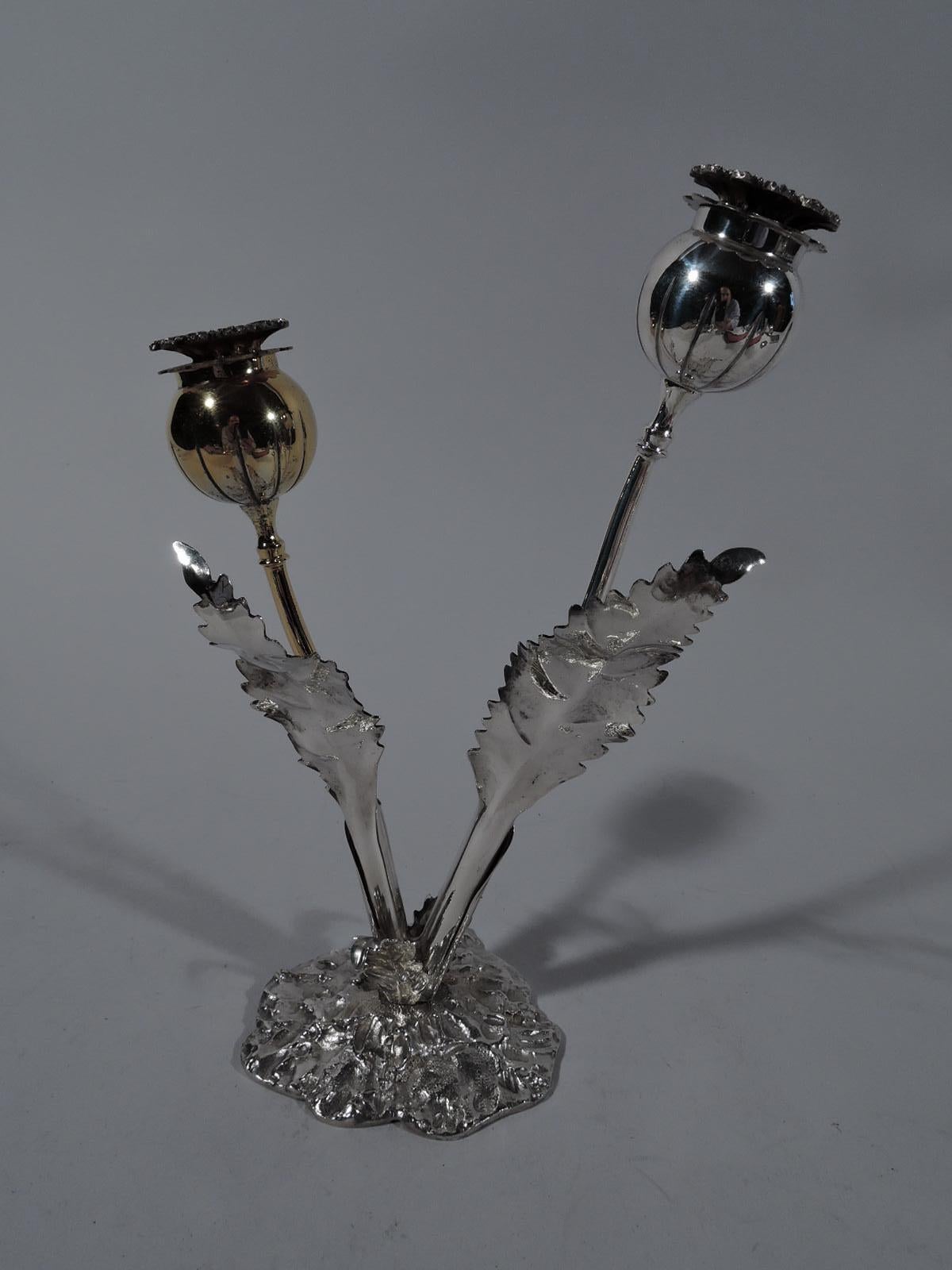 Stylish sterling silver figural salt and pepper shakers. Made by Buccellati in Milan. Two flowers (one gilt) set in Stand. Each flower has a curvilinear stem, round bud with threaded double-leaf cover (bottom leaf pierced). Stand has two holders in