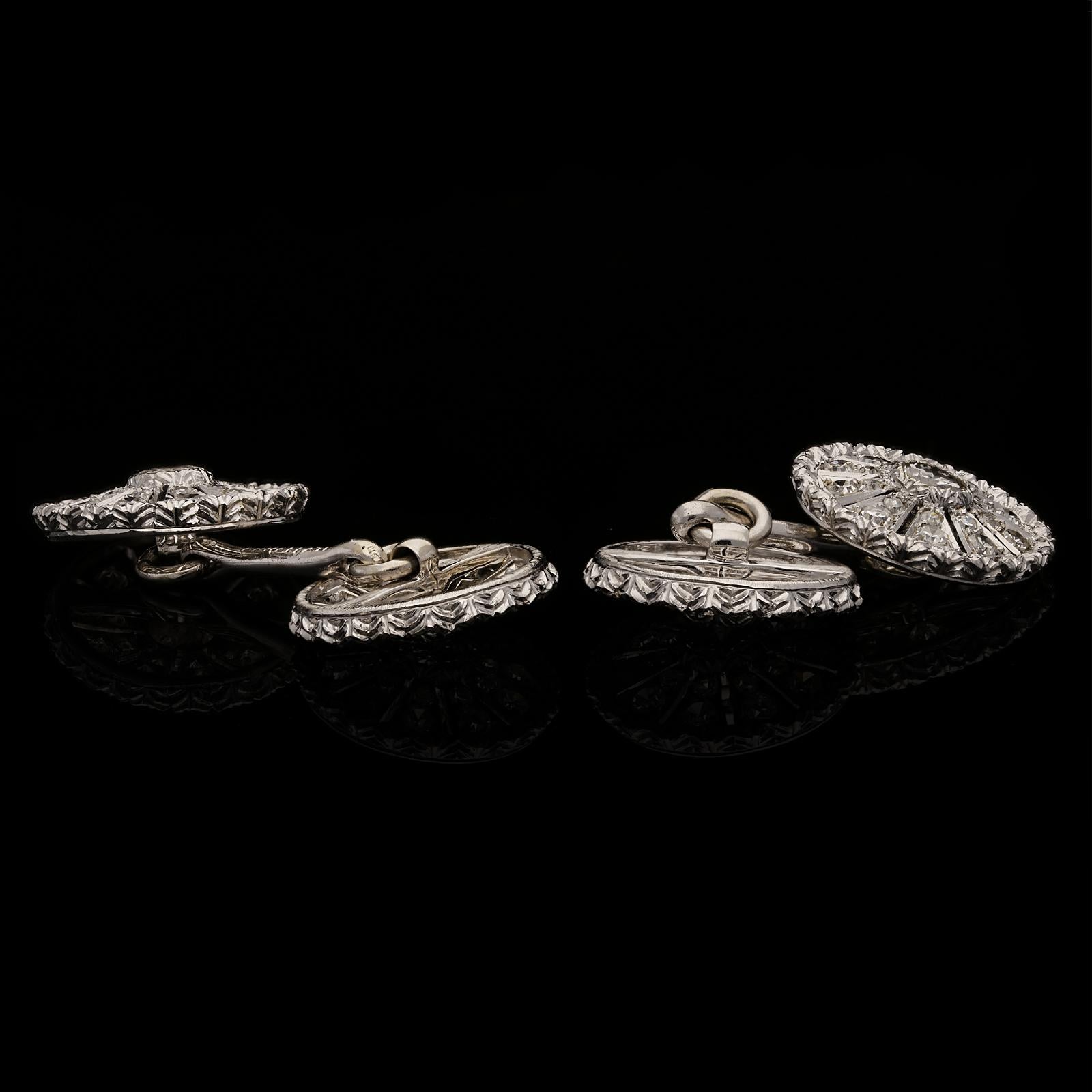 An elegant pair of diamond and platinum cufflinks by Buccellati c.1950s, the double ended cufflinks with four matching circular faces of cart wheel design, each centred with a round brilliant cut diamond in bezel setting, from which radiate ten