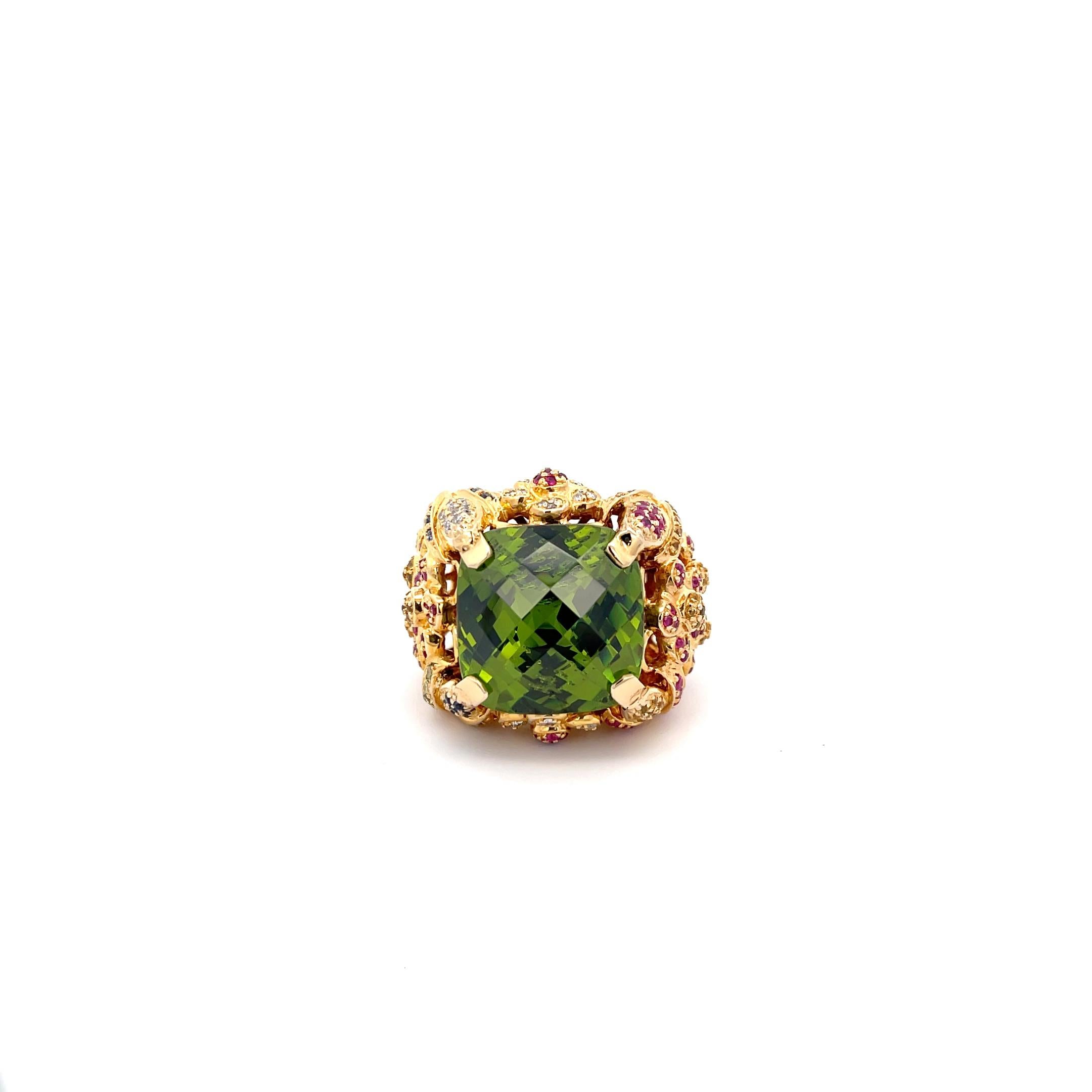 Buccellati Peridot Ring in 18K Yellow Gold. The ring features a mixed cut cushion cut peridot that approximately weighs 22 carats, accented by diamonds, rubies, and sapphires. Ring size 8 and weighs 31.6 grams.