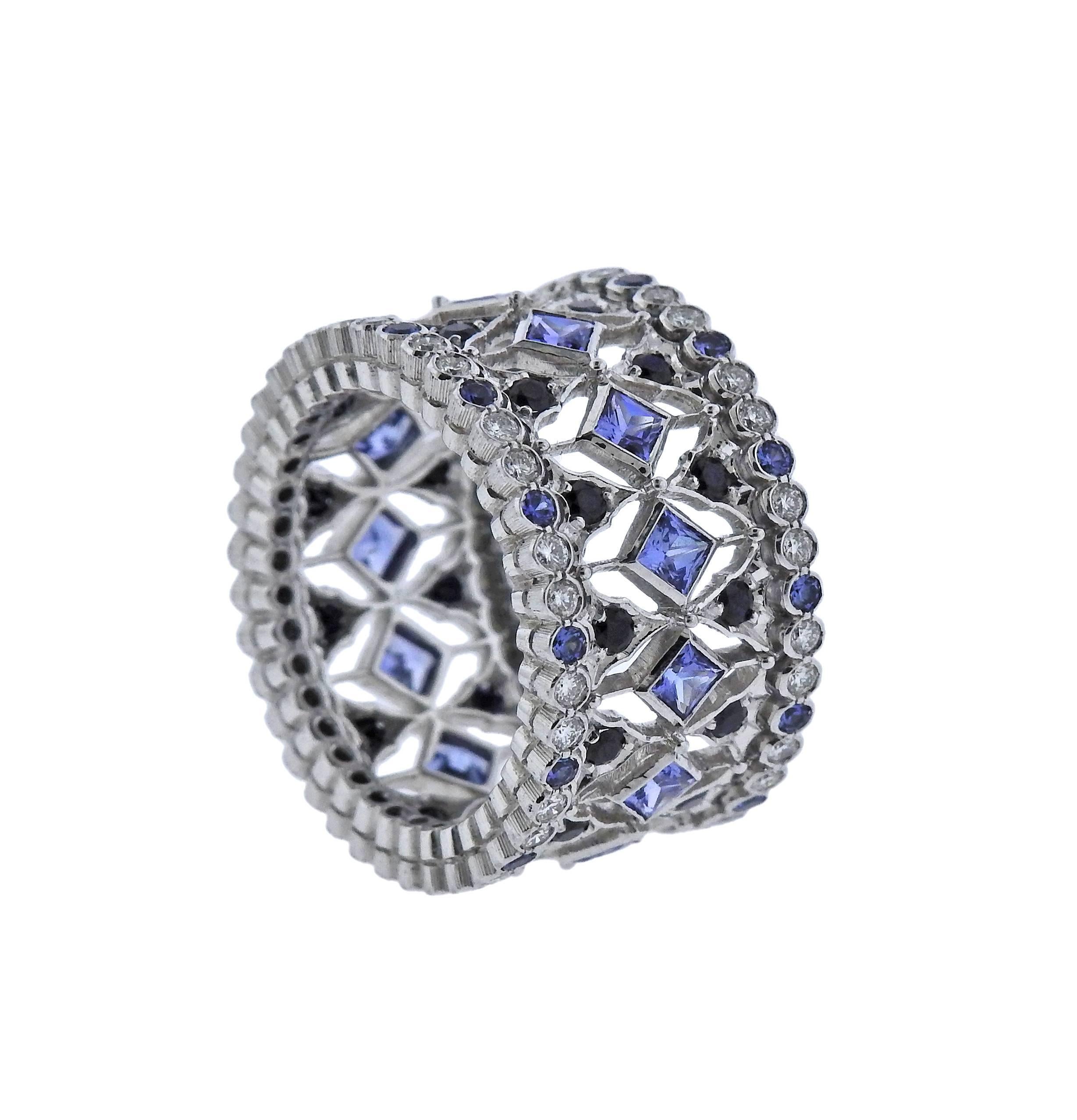 18k white gold ring crafted by Buccellati featuring approximately 0.69ctw of G/VS diamonds and approximately 2.83ctw in sapphires. Retails for $54700 . Ring size - 7, ring top is 12.3mm wide, weighs 11.4 grams. Marked: Buccellati , 750, 1.