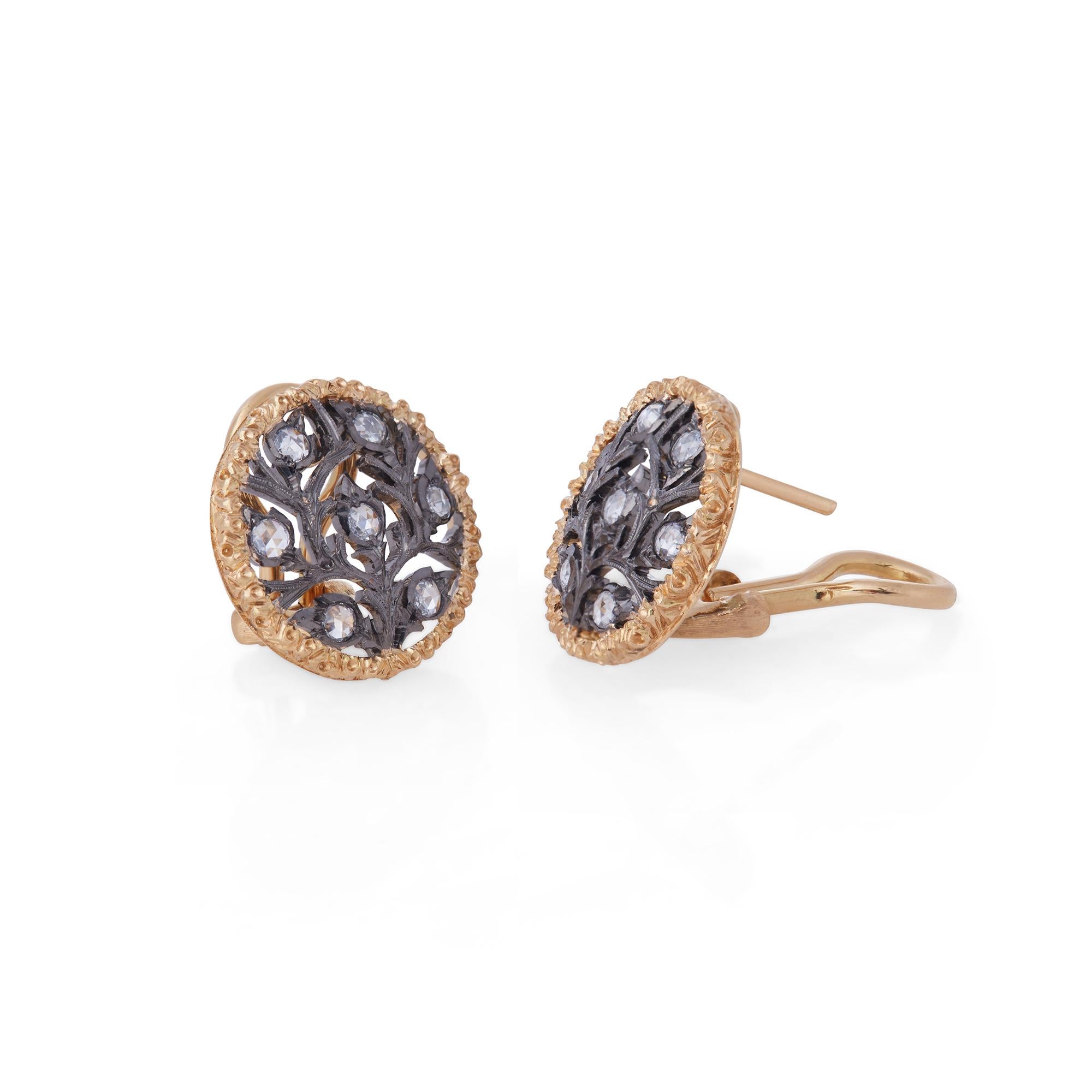 Authentic Buccellati Ramage earrings crafted in 18 karat textured yellow gold and black rhodium-plated white gold.  The foliate design is set with approximately .35 total carats of rose cut diamonds.  The earrings measure .64 inches in diameter. 