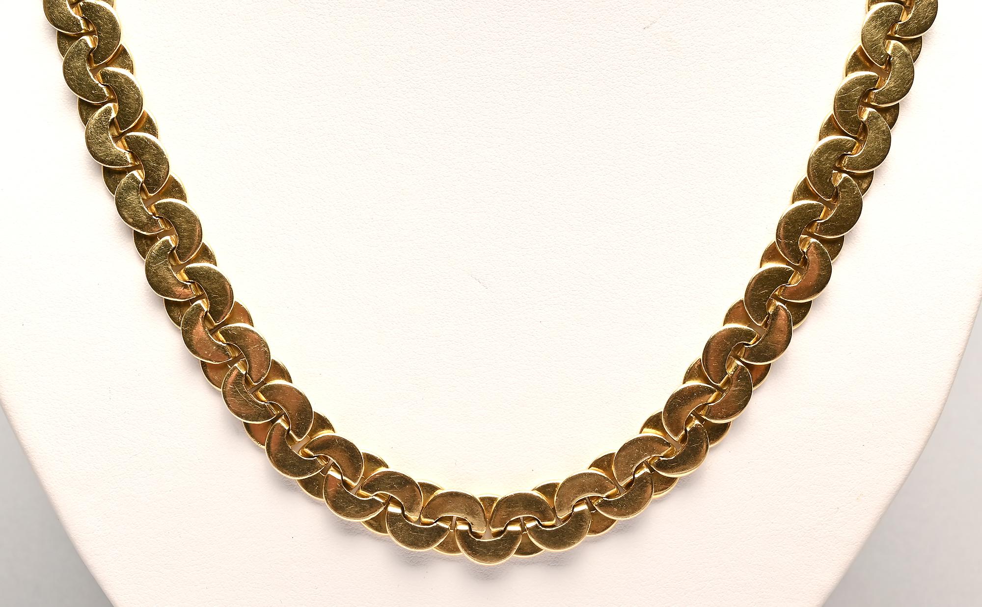 Long 18 karat gold chain necklace by Buccellati with a different finish on either side. One side is gloss and the other has a lightly textured finish made of extremely fine straight lines. The overlapping circles are closely connected to create a
