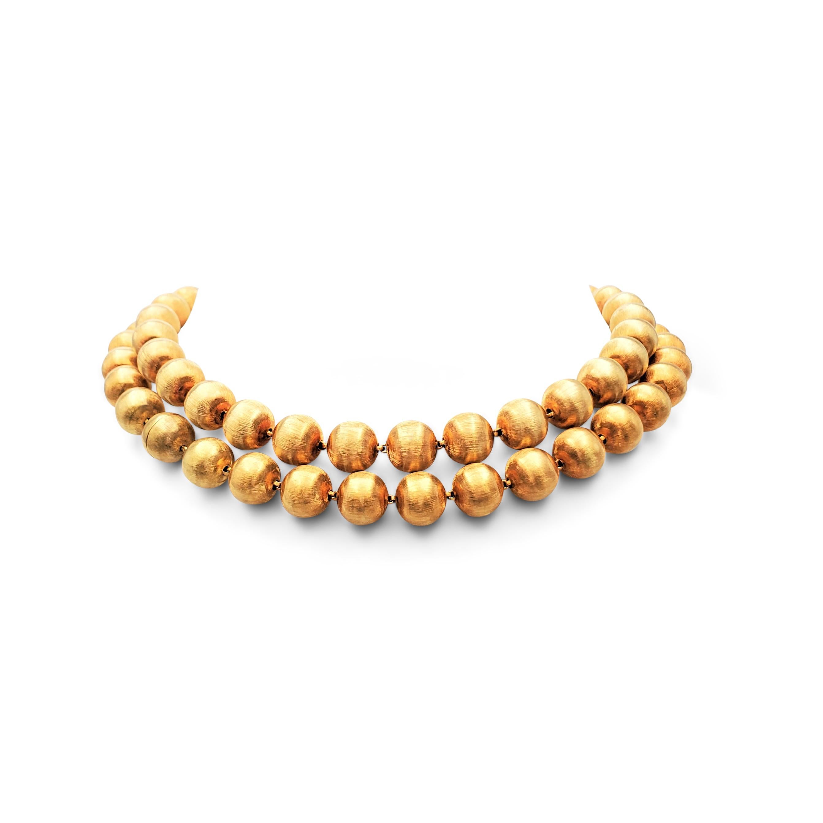 Authentic Buccellati 'Rigato' suite comprised of a necklace, composed of 18 karat yellow gold beads in a lustrous florentine finish, a pair of earrings, and a convertible necklace/bracelet set. Signed M. Buccellati, Italy, 750. Not presented with