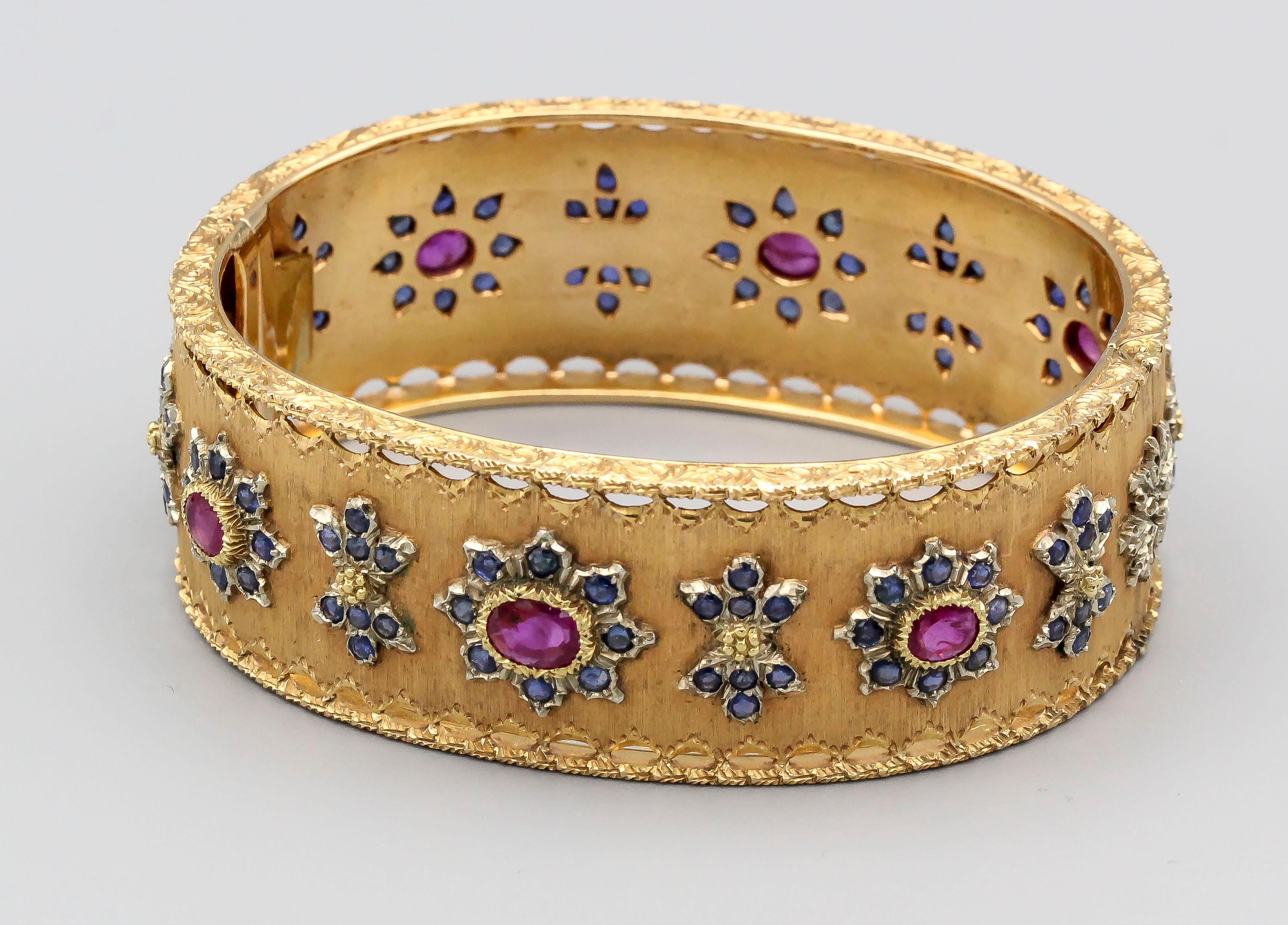 Elegant ruby, sapphire and 18K yellow gold bangle bracelet by Buccellati, circa 1950s. It features rich red rubies and blue sapphires. Comes with original display box. Will comfortably fit a 6
