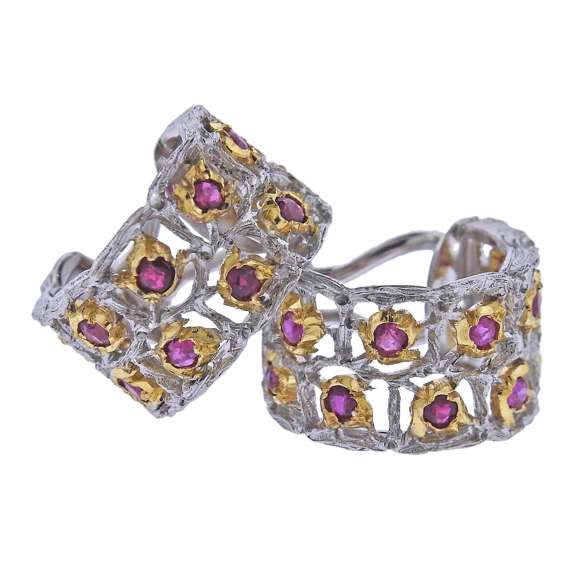 A pair of wide 18k white and yellow gold hoop earrings, crafted by Buccellati, decorated with ruby gemstones. Earrings are 17mm in diameter and 10.5mm wide . Marked: Buccellati Italy 18k. Weight - 10.2 grams 