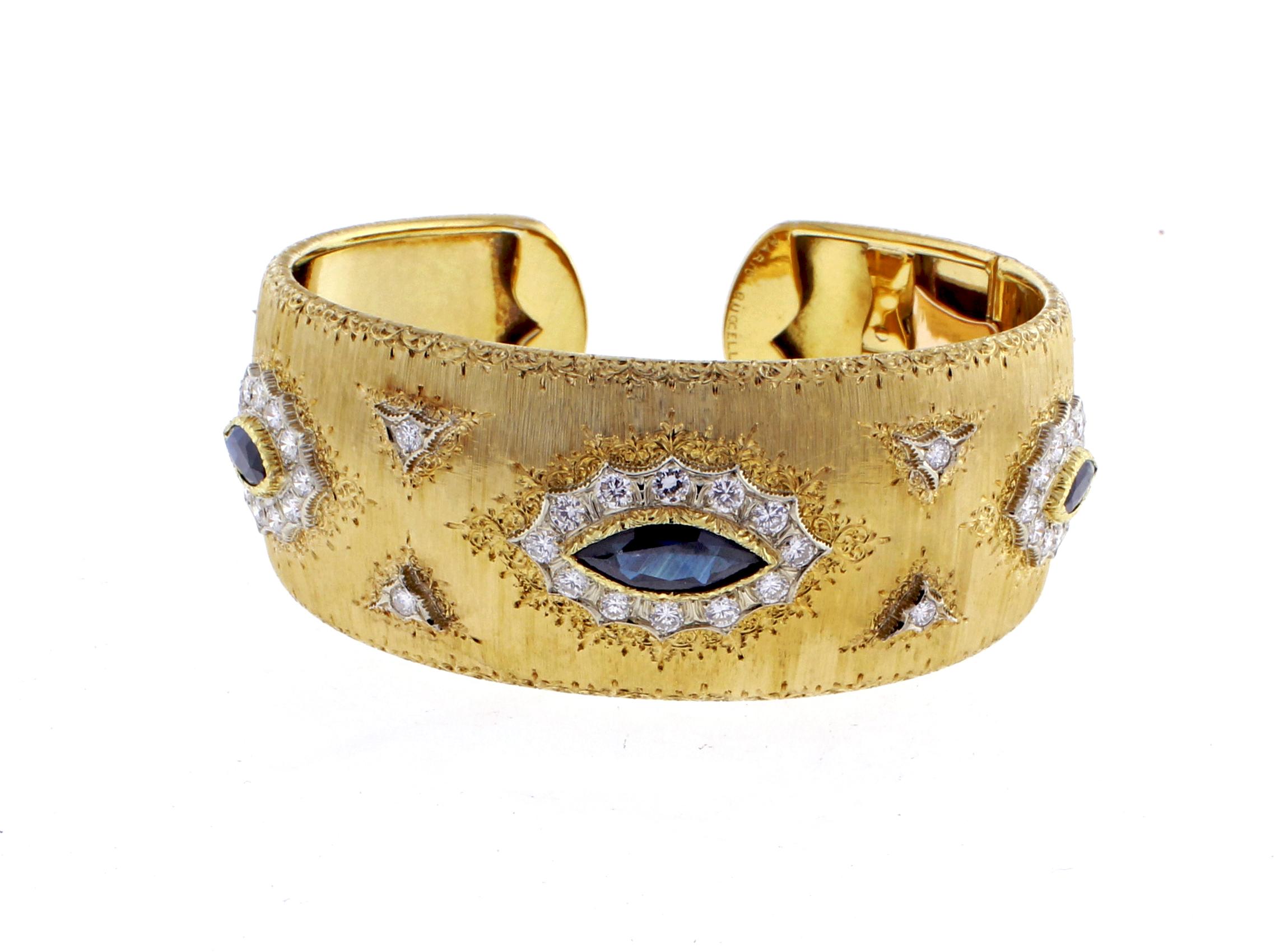 From Buccellati this hand engraved 18 karat yellow gold sapphire and diamond cuff bracelet. The bracelet features 3 marquise cut dark sapphires weighing approximately 4.5 carats and 44 diamonds weighing approximately 1.45 carats. The bracelet is