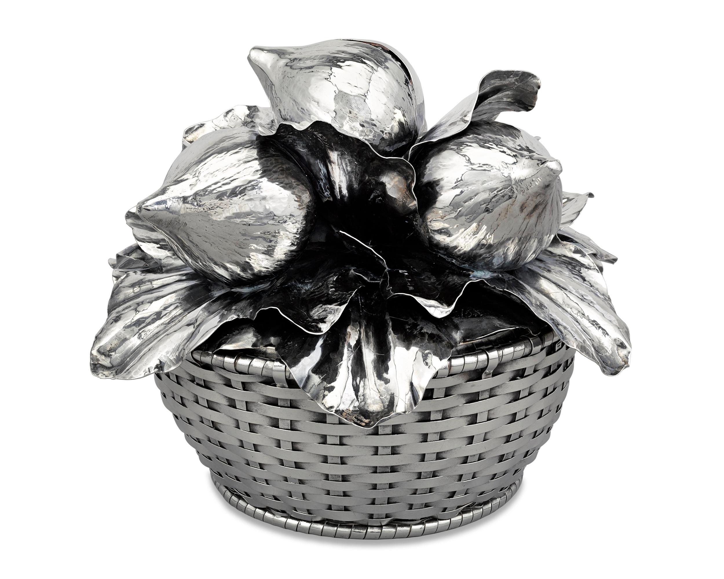 A ripe bunch of figs rest upon a bed of leaves in this exquisite silver basket centerpiece by Buccellati of Milan. Known for its innovative designs in an array of luxury goods, the Italian firm presents a truly marvelous specimen of silver artistry