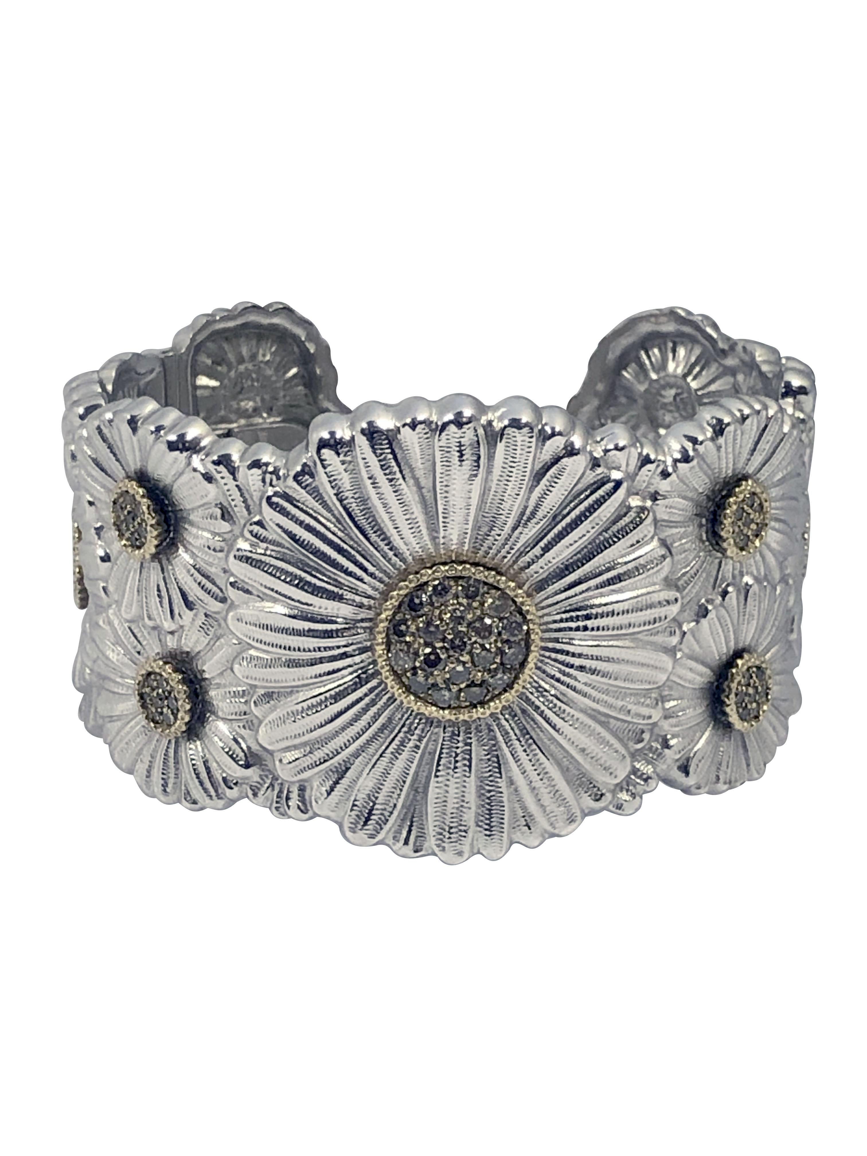 Circa 2010 Buccellati .925 Sterling Silver Daisy Cuff Bracelet, measuring 1 1/2 inches wide at the top and having Gold accented Bezels around the Flower settings that are set with Fancy Color Cognac Diamonds totaling approximately 1 carat. Heavy