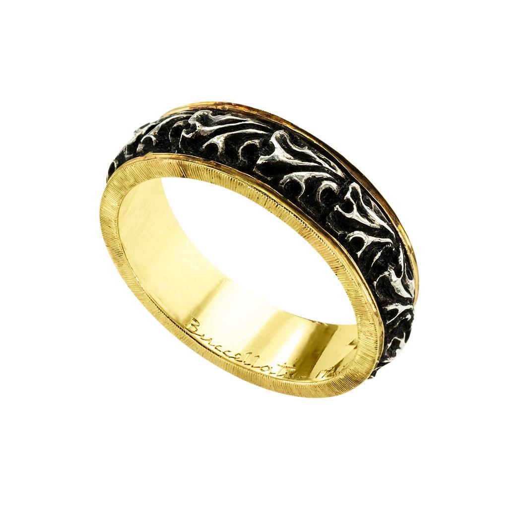 Buccellati silver and gold wedding ring. *

ABOUT THIS ITEM:  #R-DJ829F. Scroll down for specifications.  5.5 mm wide continuously decorated by an organic motif of oxidized silver within a yellow gold border highlighted by a coin edge notch detail. 