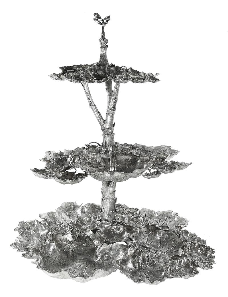 Buccellati silver grape vine tiered centerpiece in sterling silver.

Buccellati grape vine three-tiered serving tray measures approximate 22? in overall height. Top tray diameter is approx. 10? with a 3? height. Middle tray diameter is approx. 15?