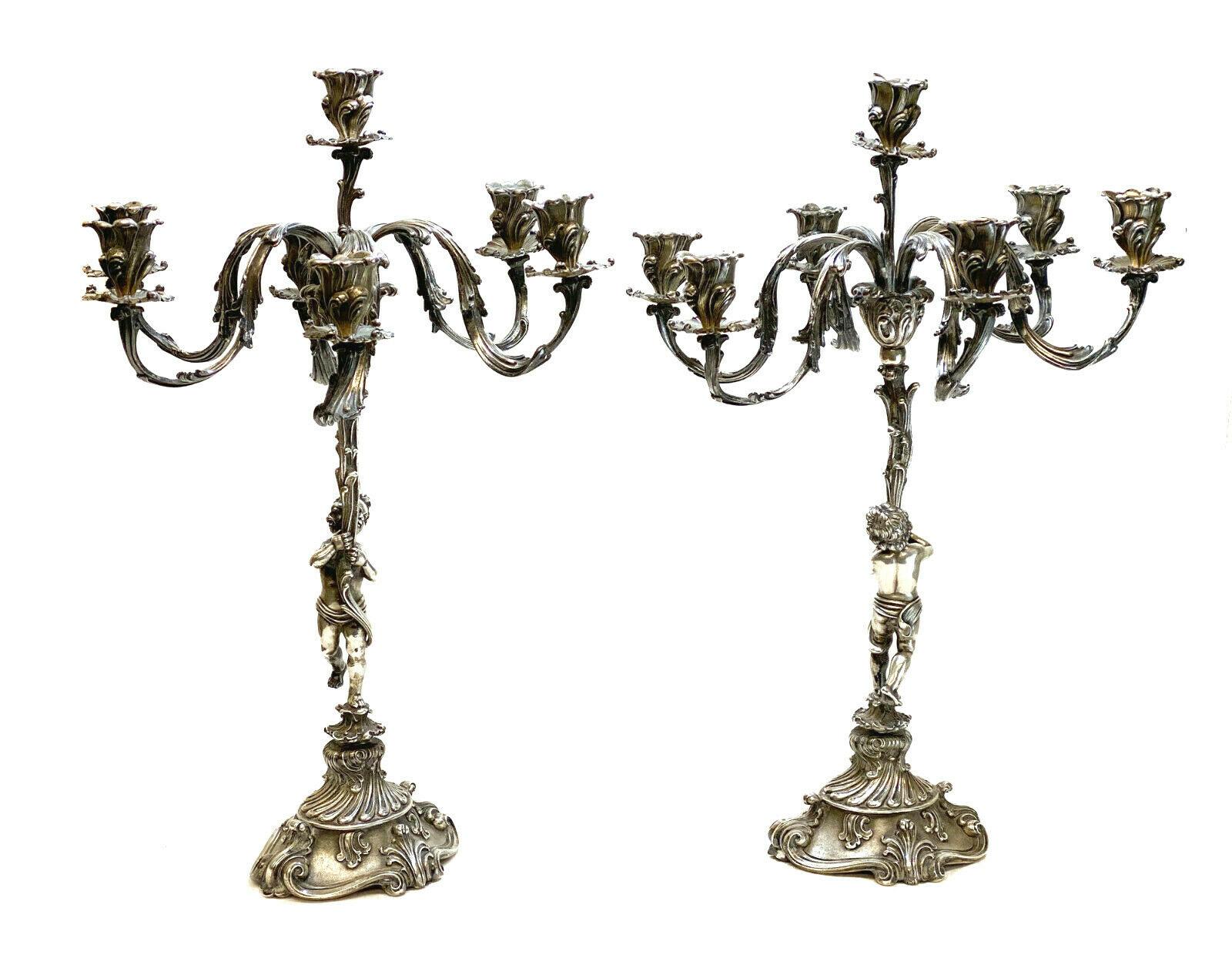 Buccellati Italian sterling silver 7-light candelabras, circa 1950. Figural cherubs to the stem. Hand chased flowers and foliate accents throughout. Marked 