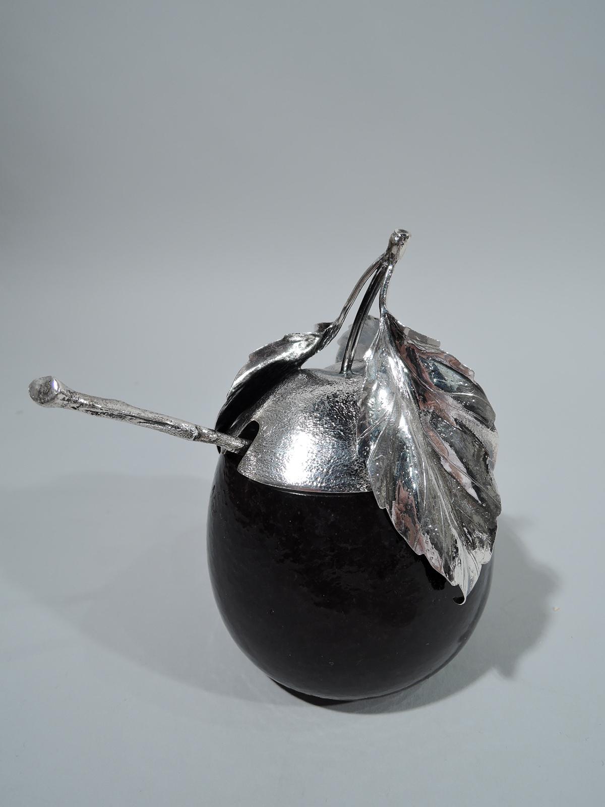 Figural plum sterling silver and glass jam jar with spoon. Made by Buccellati in Milan. Jar is Murano glass in shaped oval with truncated top and cutout spoon rest. Exterior is glossy with irregularities suggestive of fruit skin. Interior white.