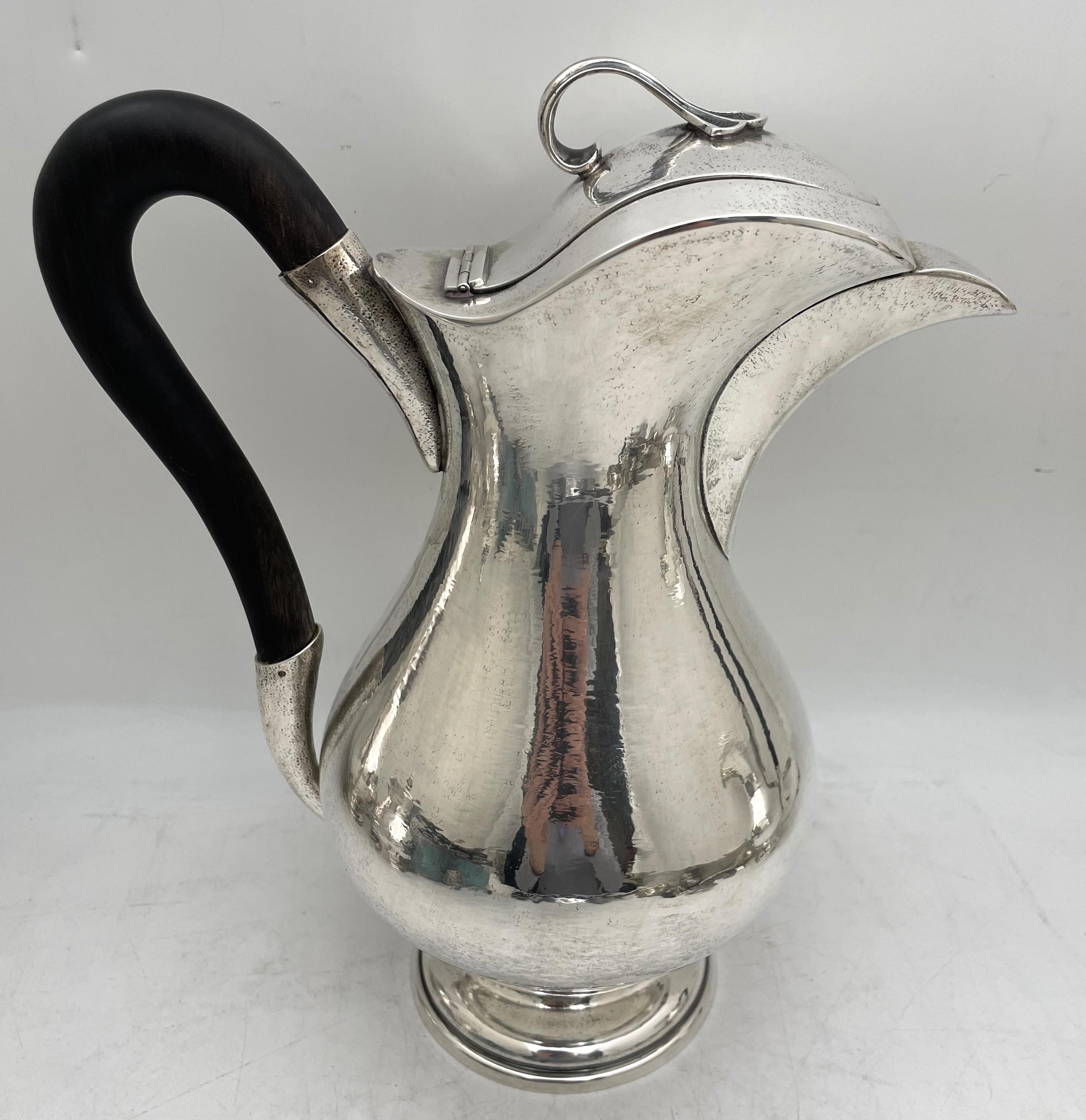 Buccellati sterling silver hand-hammered 4-piece tea and coffee set, beautifully adorned with stylized, geometric finials, consisting of:

- a coffee pot measuring 11 1/4'' in height by 9 3/4'' from handle to spout

- a tea pot measuring 9 2/3'' in