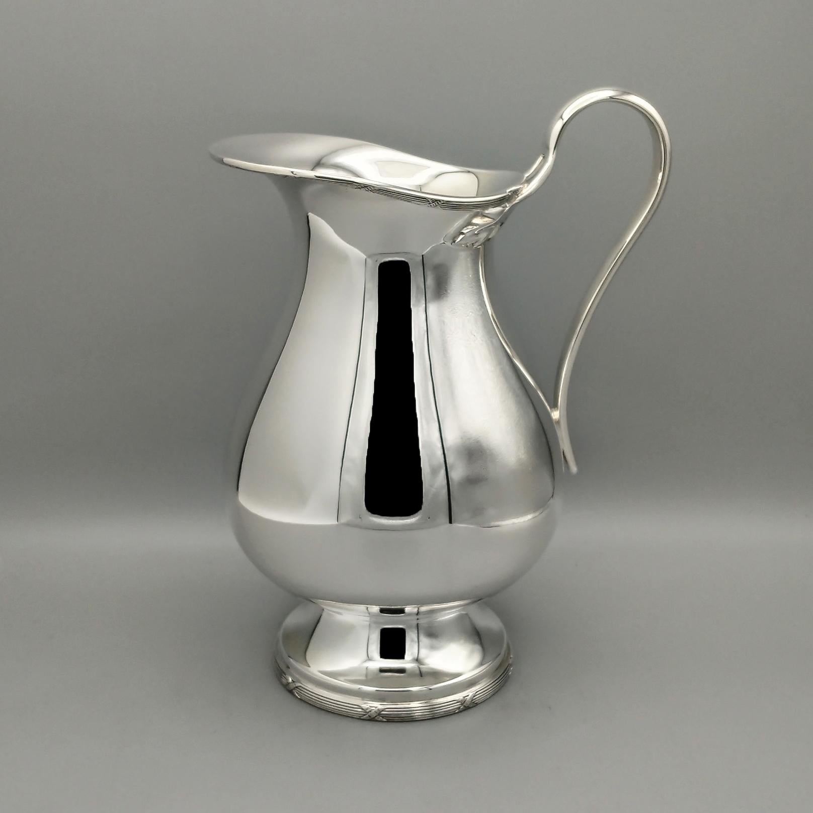 Sterling silver jug by Gianmaria Buccellati.
The body and base of the jug are rounded and completely smooth.
A border with a striped and ribbon design typical of the Louis XVI style has been soldered to the bottom and the end of the upper part of