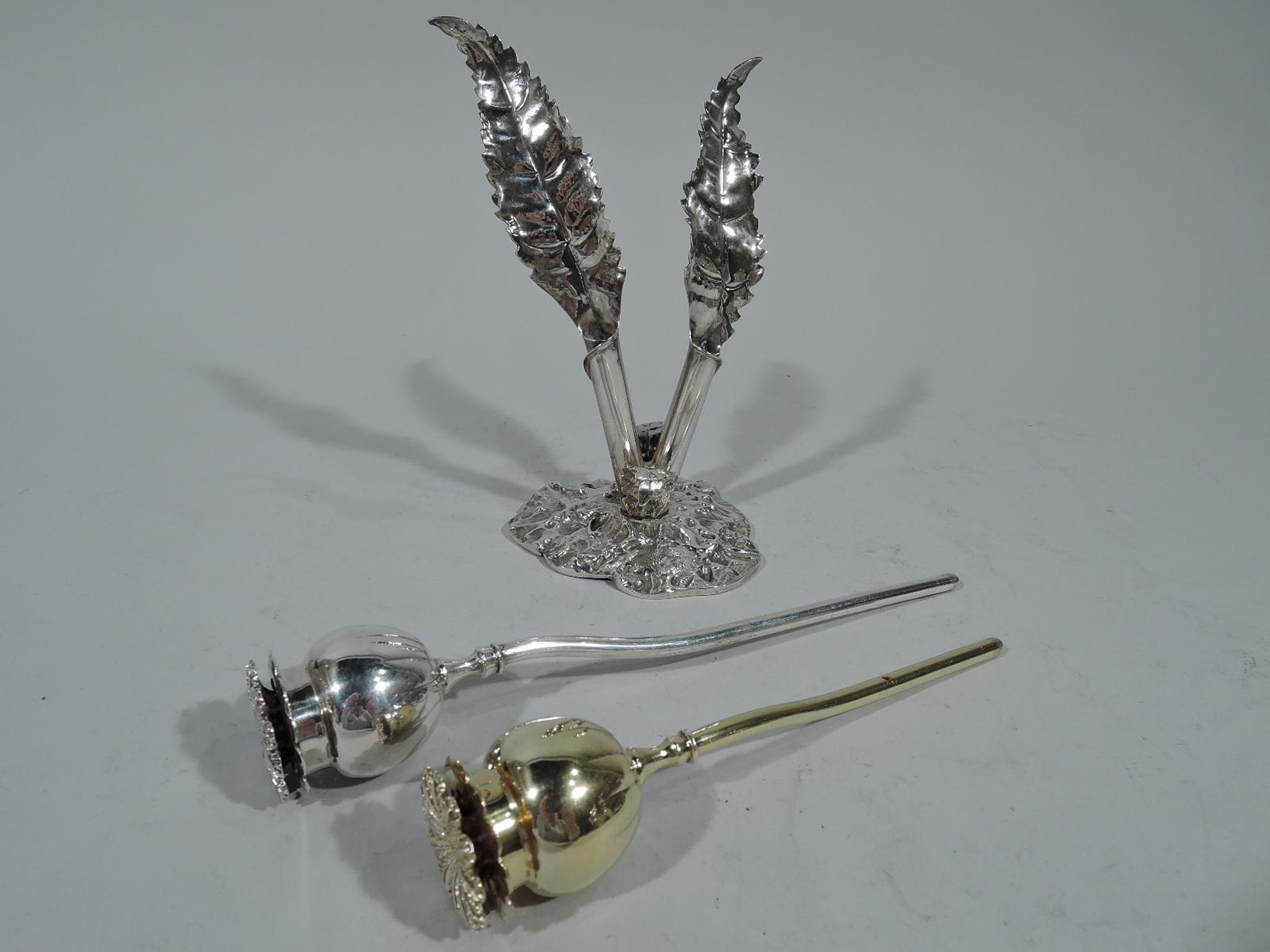 Unusual sterling silver salt and pepper shakers. Made by Buccellati in Milan. Two flowers (one gilt) set in stand. Each flower has a curvilinear stem, round bud with threaded double-leaf cover (bottom leaf pierced). Stand has two holders in form of