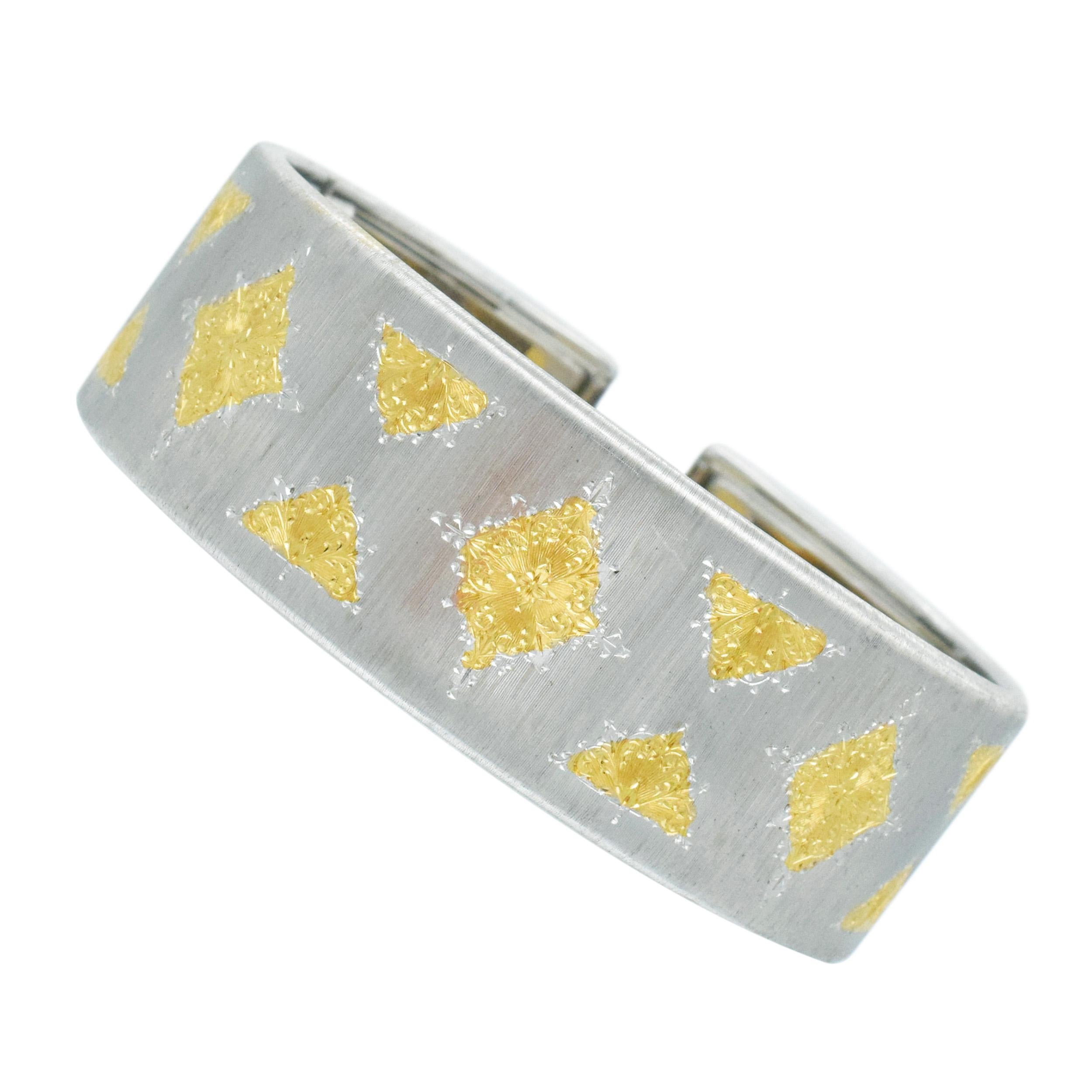 (BUCCELLATI) Style Gold Cuff Bracelet. This cuff is crafted in 18k white gold with
brushed finish, accented with 18k yellow gold geometric inlays. Equipped with hinged closure.
Stamped: 750 and Italian gold marks Width: 21mm. Inside diameters: