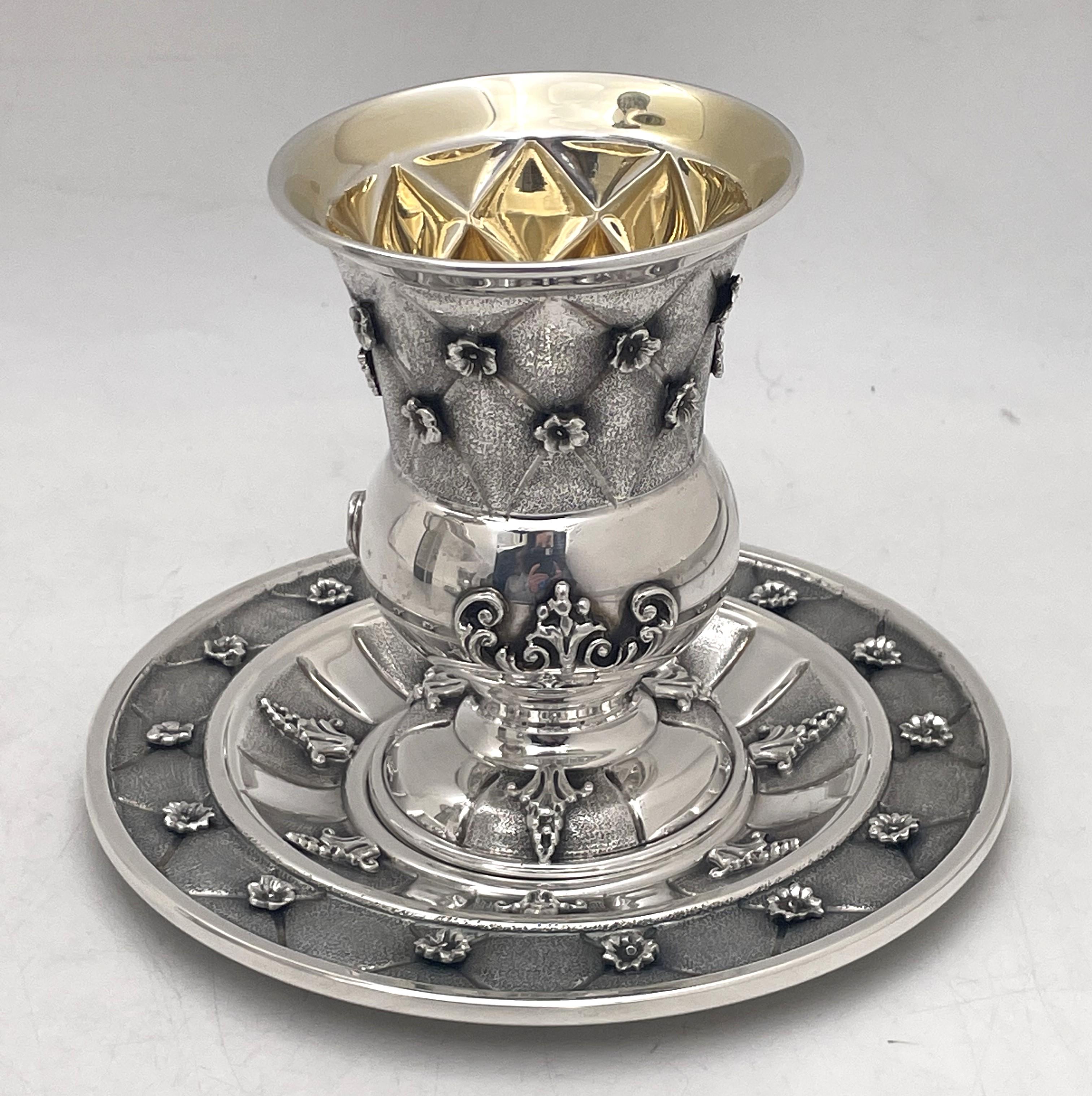 Italian sterling silver Kiddush cup and saucer, in Buccellati style, with applied floral motifs and beautifully embossed. The cup measures 4 1/2'' in height by 3'' in diameter while the saucer measures 6 1/4'' in diameter. With heavy gage, the total