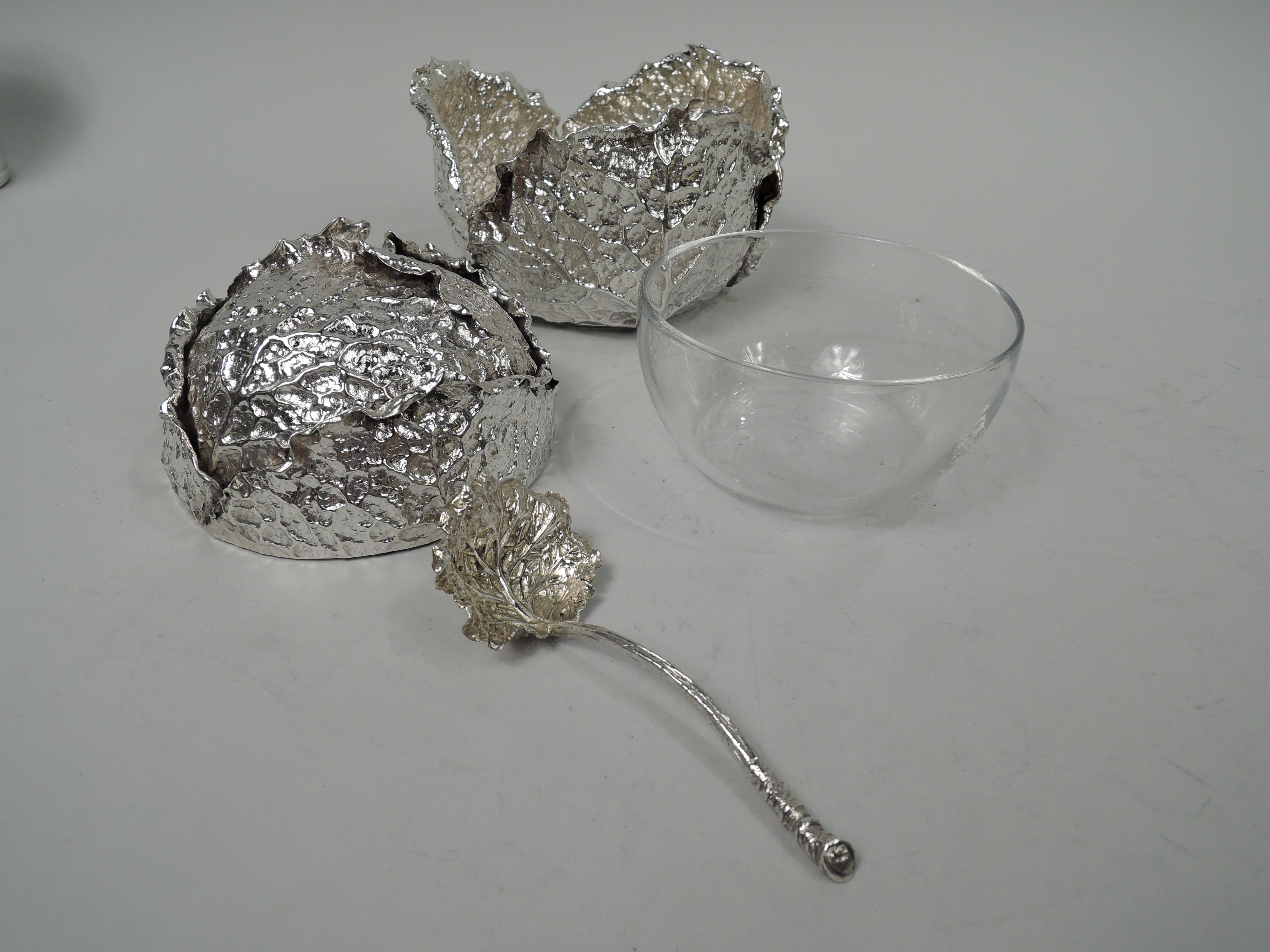 Stylish and jokey sterling silver cabbage head sauce bowl and ladle. Made by Buccellati in Italy. Domed cover set in bowl, both comprising overlapping leaves with realistic veins and irregularities. Ladle has branch handle and leaf bowl. Clear glass