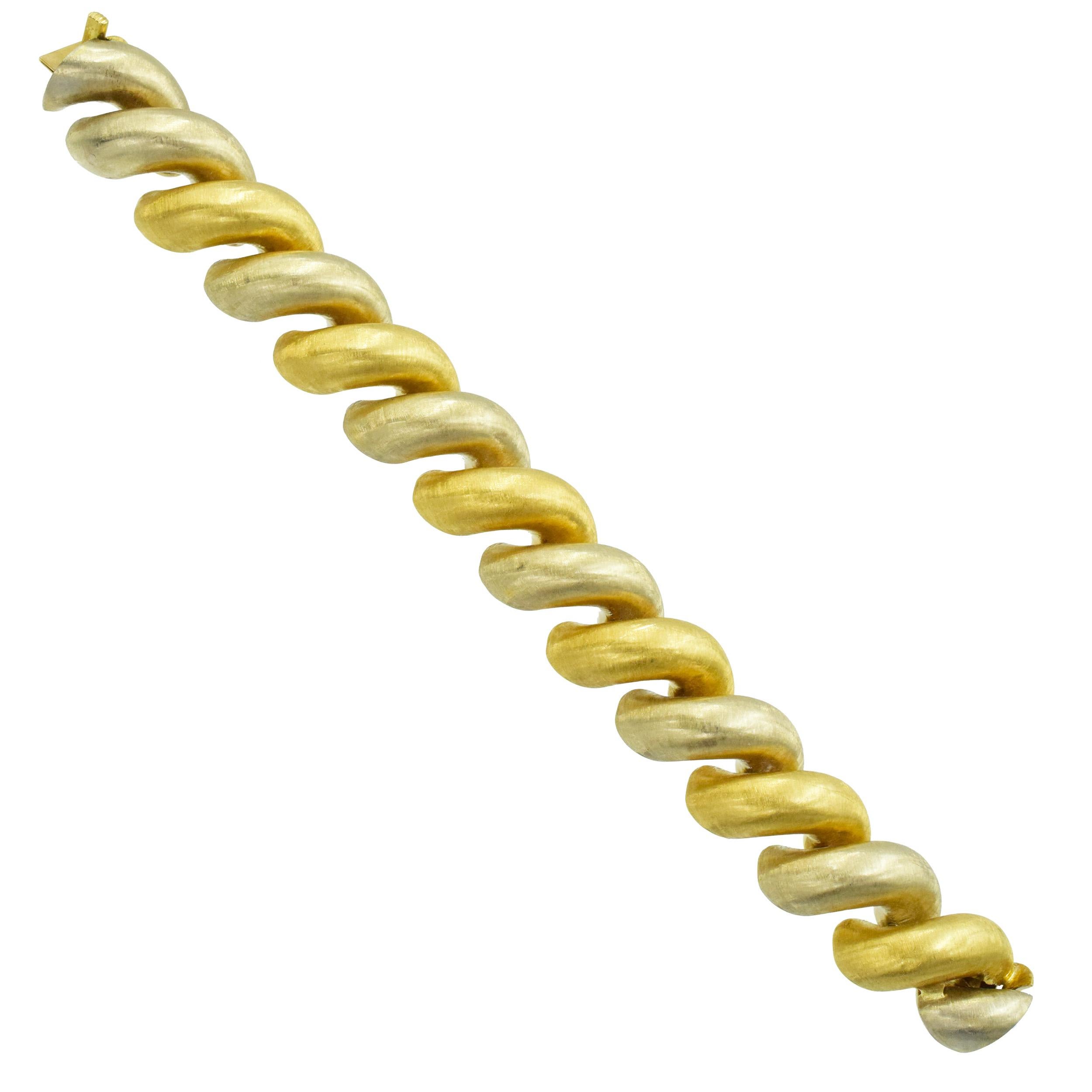 Buccellati Torchon San Marco Link bracelet in 18k two tone gold. The bracelet alternates
seven 18k yellow and six 18k white gold classic Macaroni slyle links with iconic Buccellati satin finish. Equipped with box clasp, secured with fold over safety