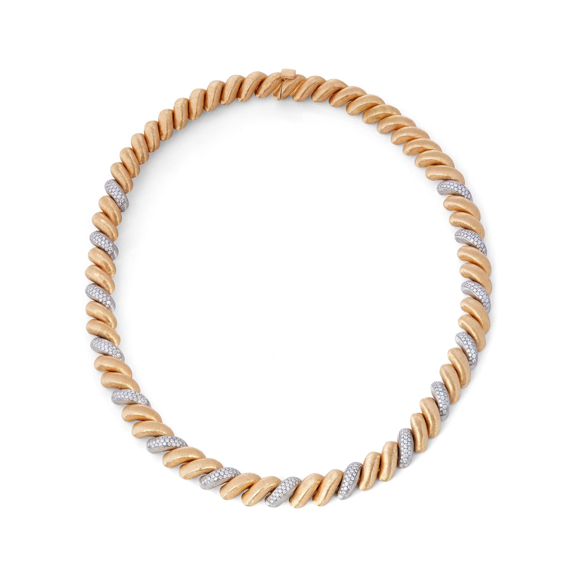 Authentic Buccellati Torsadé necklace crafted in 18 karat yellow and white gold.  Featuring brushed gold yellow gold links with the brand's iconic Florentine finishing alternating with diamond encrusted white gold links for an estimated 2 carats