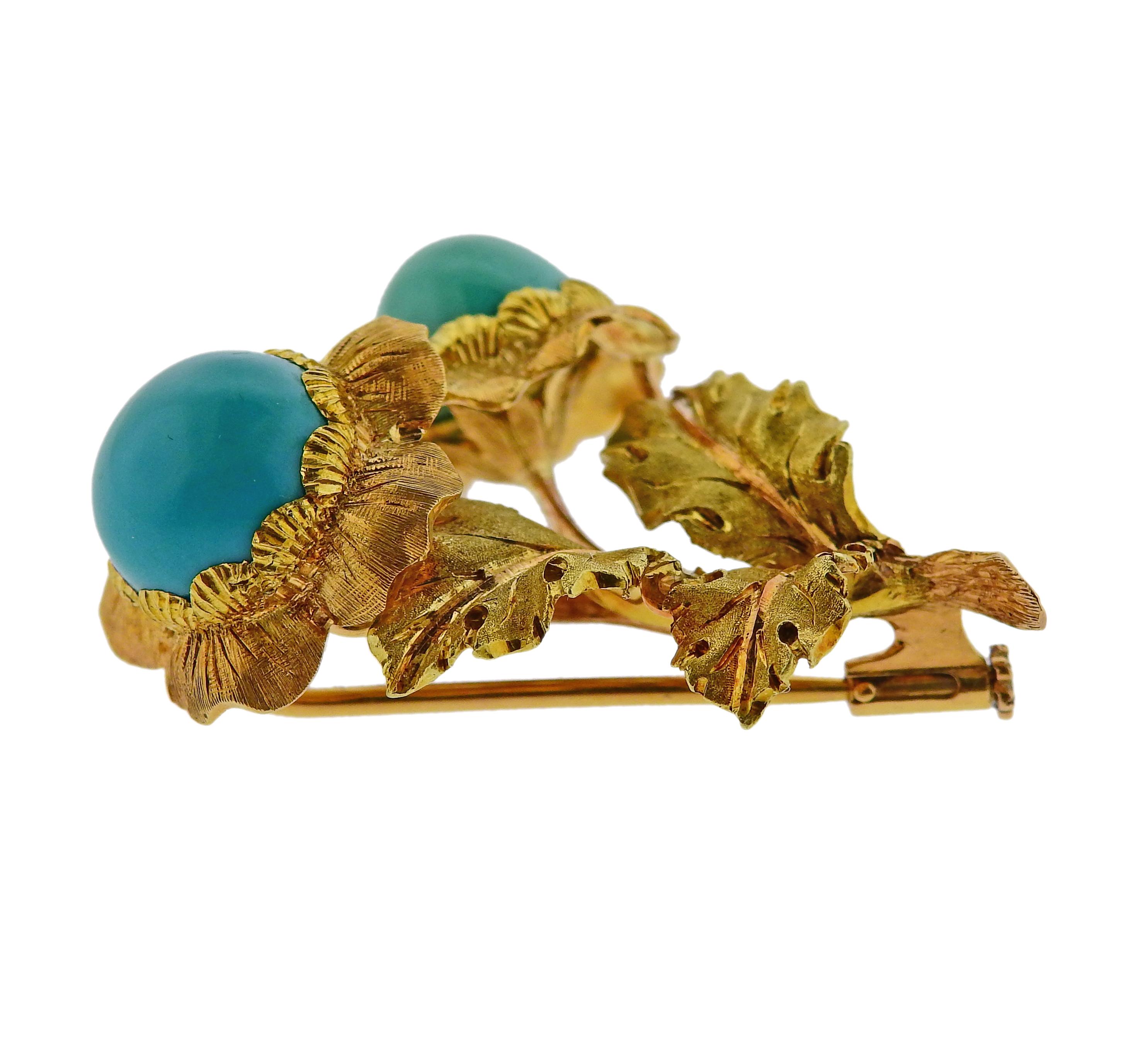 18k yellow gold brooch by Buccellati, featuring two flowers set with turquoise. Measures 40mm x 28mm. Marked Buccellati. Weighs 14.3 grams.