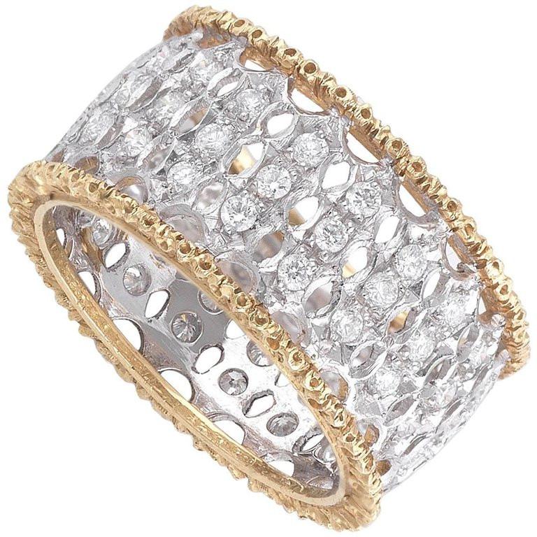 Yellow and white Gold with studded Diamonds, size 7, weight 6,4 gr, wide 1,1 cm.