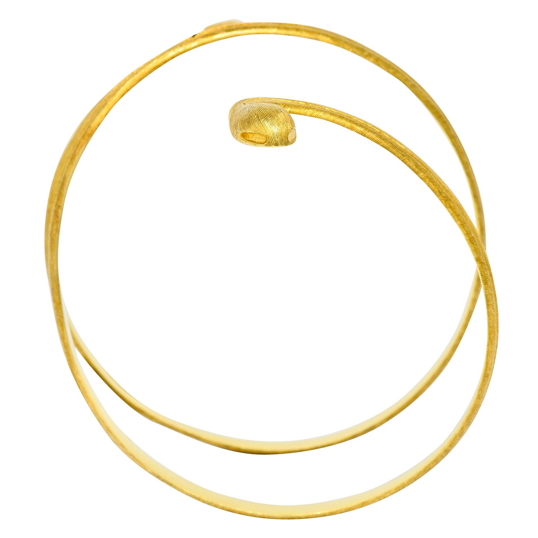 Armband bracelet is designed as a coiling snake

With a strongly brushed finish and a slightly raised milgrain spine

Stamped 18K and 750 for 18 karat gold

And signed Buccellati Italy with an Italian assay mark

Circa: 1970s

Inner circumference: