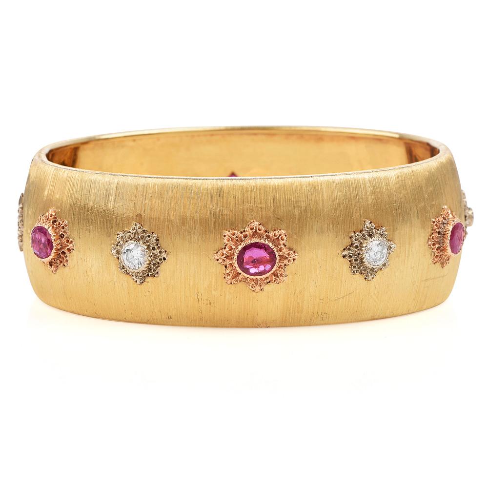 Compliment your wardrobe with this Expertly Executed Vintage 1960's Buccellati Ruby and Diamond Cuff Bracelet with an approx total weight of 47.0 grams.

Crafted in solid 18K yellow gold, featuring the Rigato effect characteristic of the