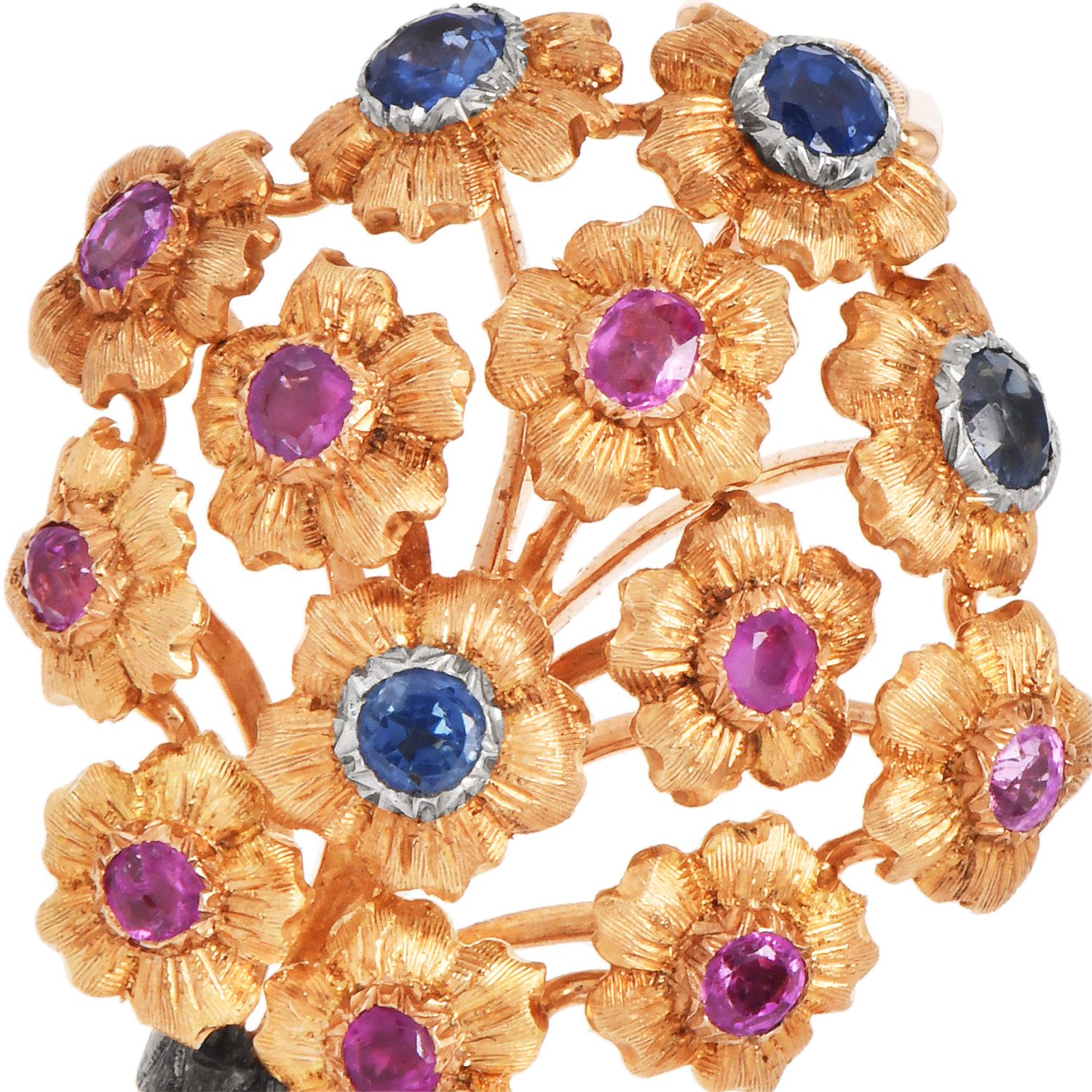 Vintage Buccellati brooch of a blooming bouquet, crafted in 18K yellow gold. Set with rubies and sapphires, a timeless celebration of nature and color. Each gemstone is nestled in finely detailed petals, showcasing the house's signature attention to