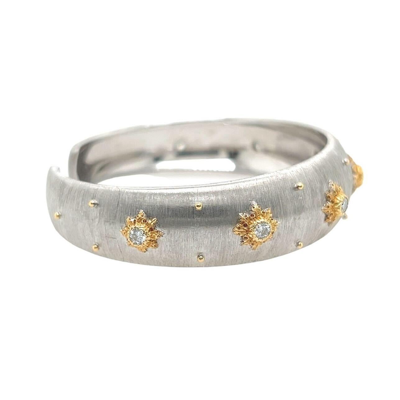 An 18 karat white and yellow gold and diamond bracelet, Buccellati.  The “Macri” bracelet designed as a hinged brushed white gold cuff applied with seven rosettes of yellow gold, each set with a brilliant cut diamond, further decorated with eighteen