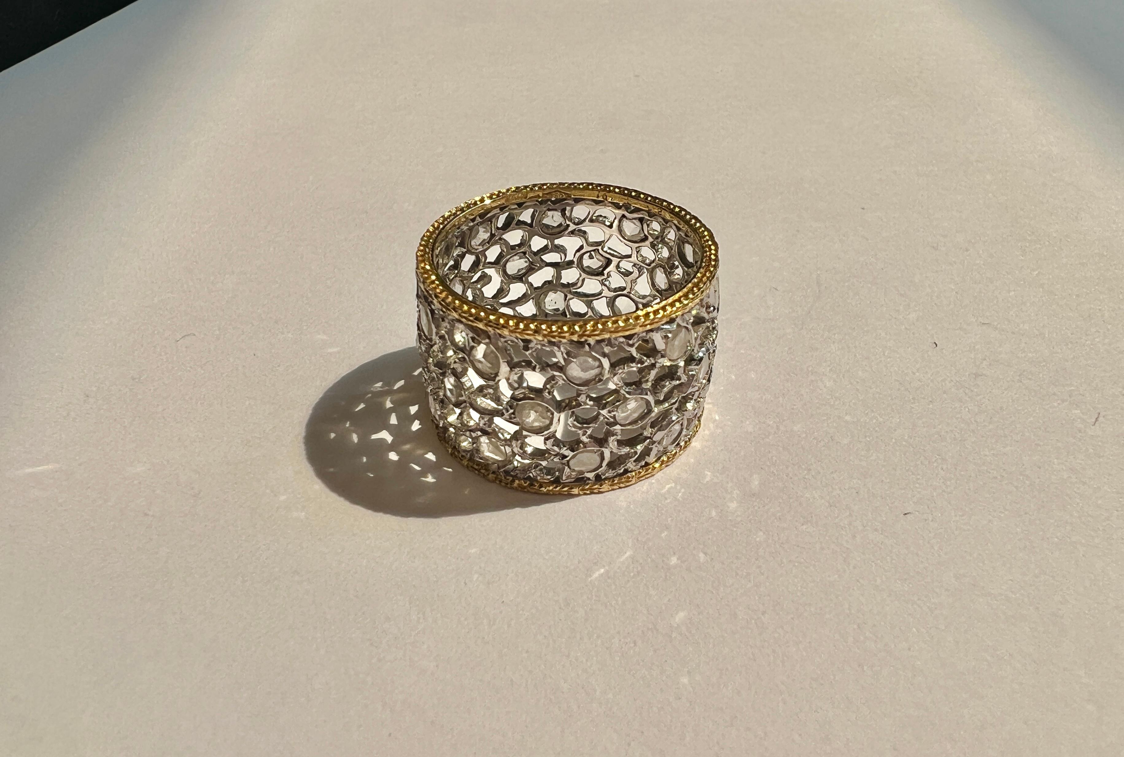 Buccellati White and Yellow Gold Eternelle Band Ring

Details:
Lace design ring, decorated engravings and diamonds. The Eternelle ring by Buccellati, with its extreme simplicity and lightness. 
Ring size 6.5. 
Weight 5.6 grams
In excellent condition