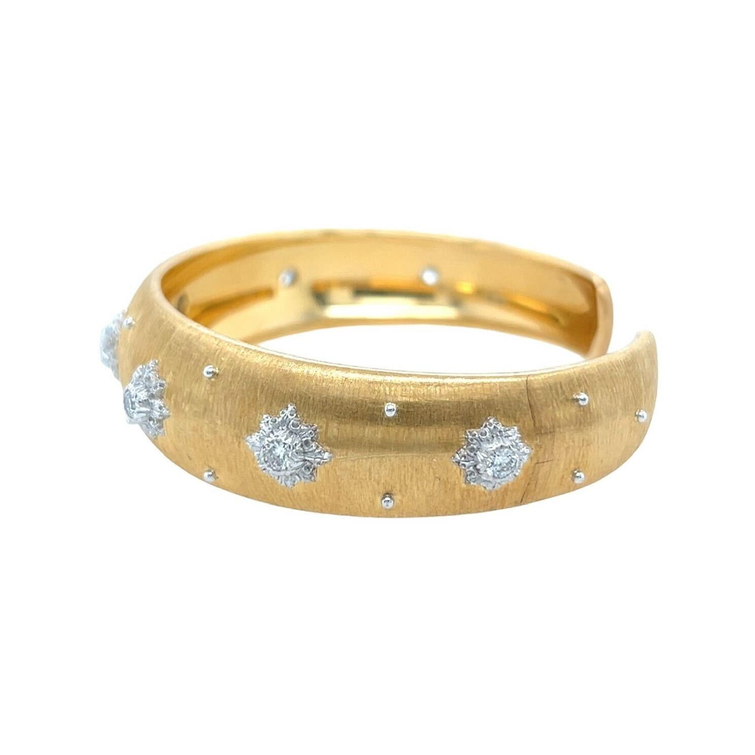 An 18 karat yellow and white gold and diamond bracelet, Buccellati.  The “Macri” bracelet designed as a hinged brushed yellow gold cuff applied with seven  rosettes of white gold, each set with a brilliant cut diamond, further decorated with