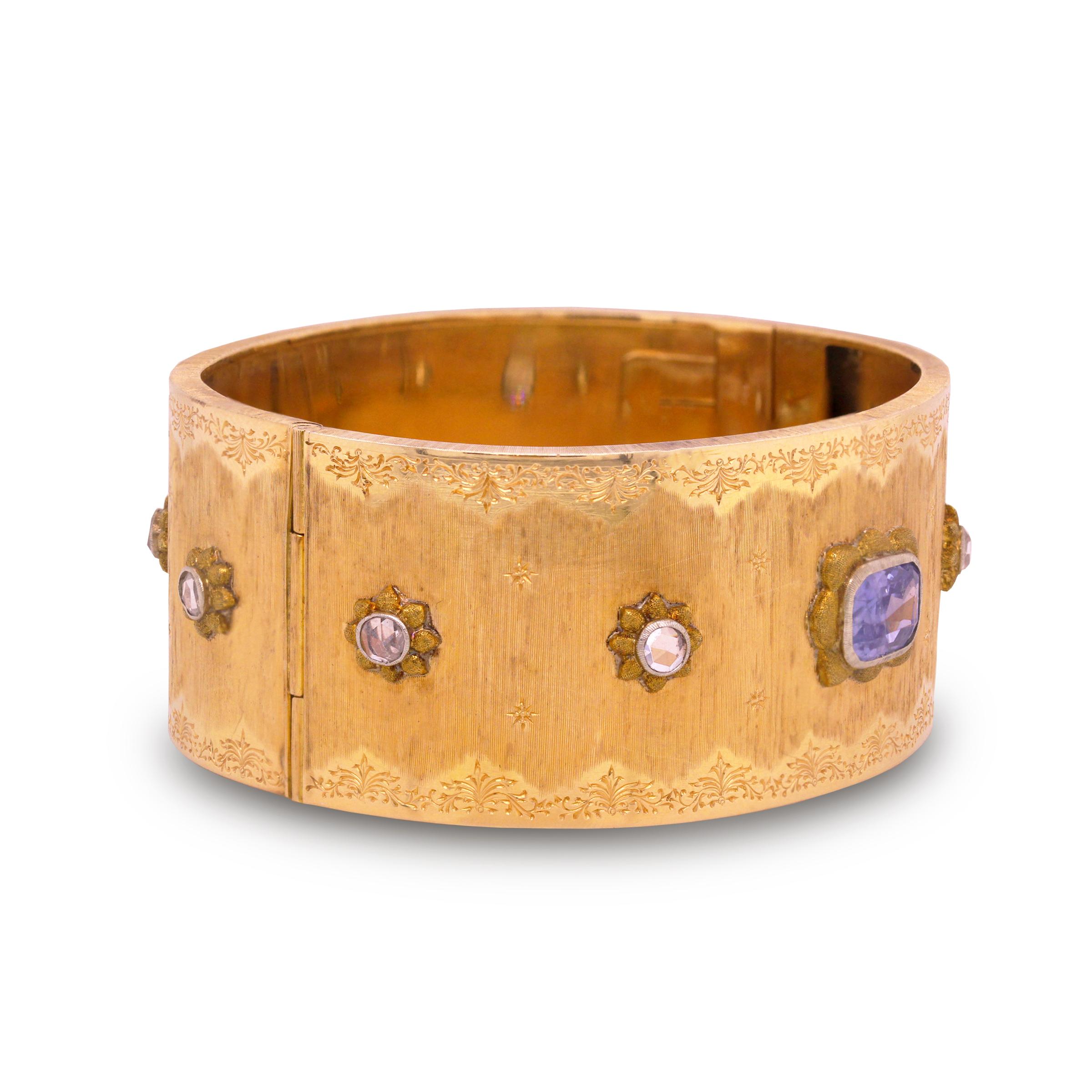 18K Yellow Gold Cuff Bangle Bracelet by Buccellati with Rose Cut Diamonds and No Heat Blue Sapphire Center

This state-of-the-art cuff bracelet by italian jewelry house, Buccellati is truly an incredibly handcrafted piece

All hand engraved with