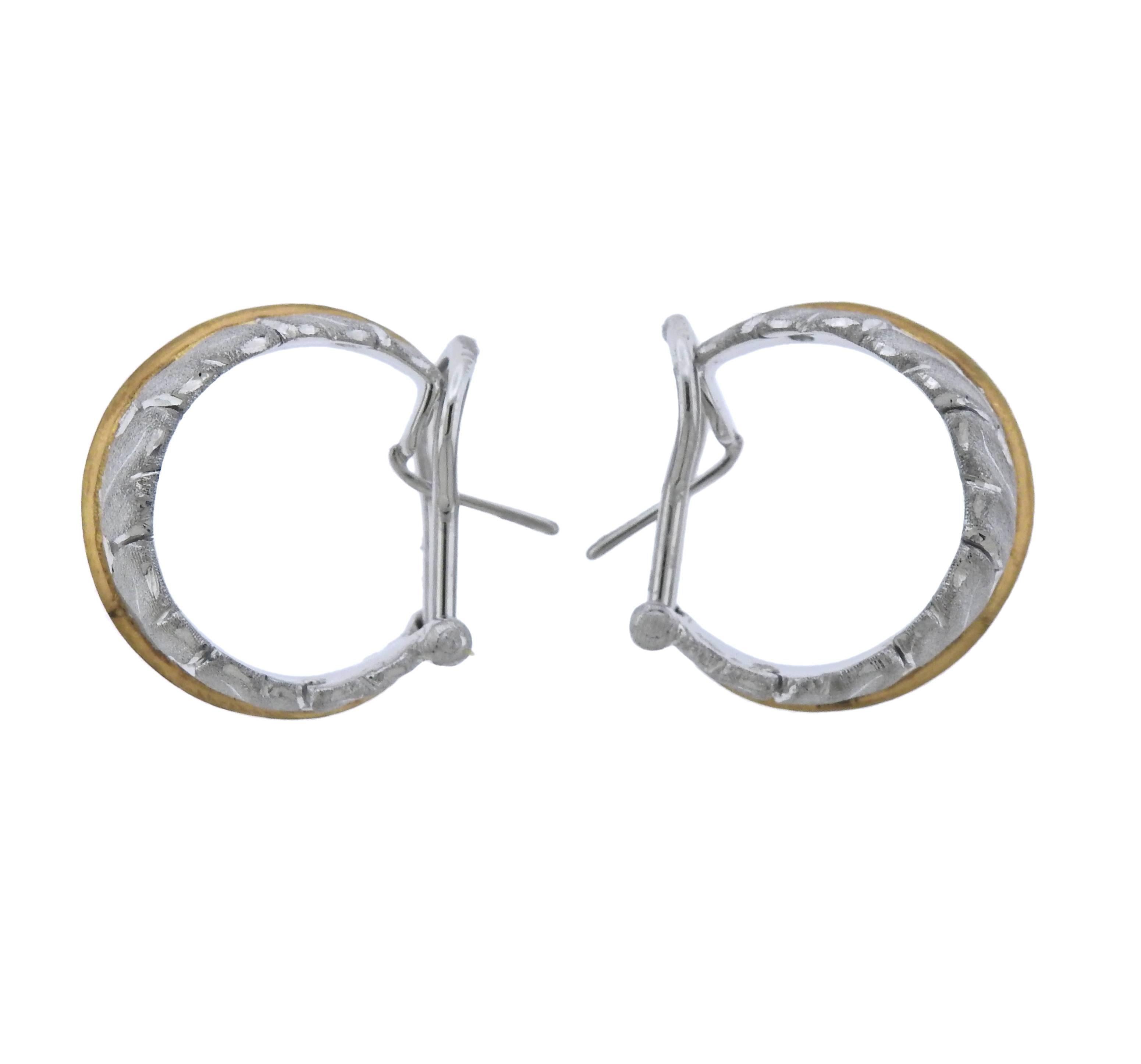 Pair of 18k white and yellow gold hoop earrings, featuring iconic leaf motif. Crafted by Buccellati, Retail $11100.  Earrings 20mm x 11mm, weigh 20.1 grams. Marked: Buccellati, Italy 18k, R6191.