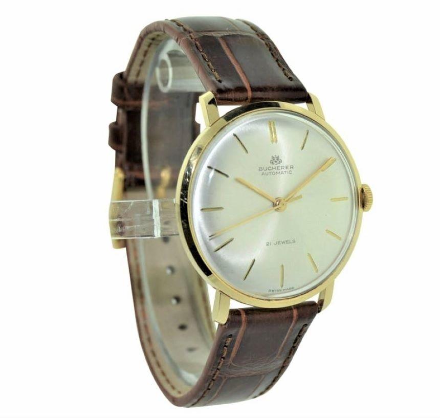 FACTORY / HOUSE: Bucherer Watch and Jewelry Company
STYLE / REFERENCE: Round / Dress Model
METAL / MATERIAL:  18kt. Solid Gold
CIRCA: 1960's 
DIMENSIONS: 39mm X 34mm
MOVEMENT / CALIBER: Winding / 21 Jewels 
DIAL / HANDS:
ATTACHMENT / LENGTH: 