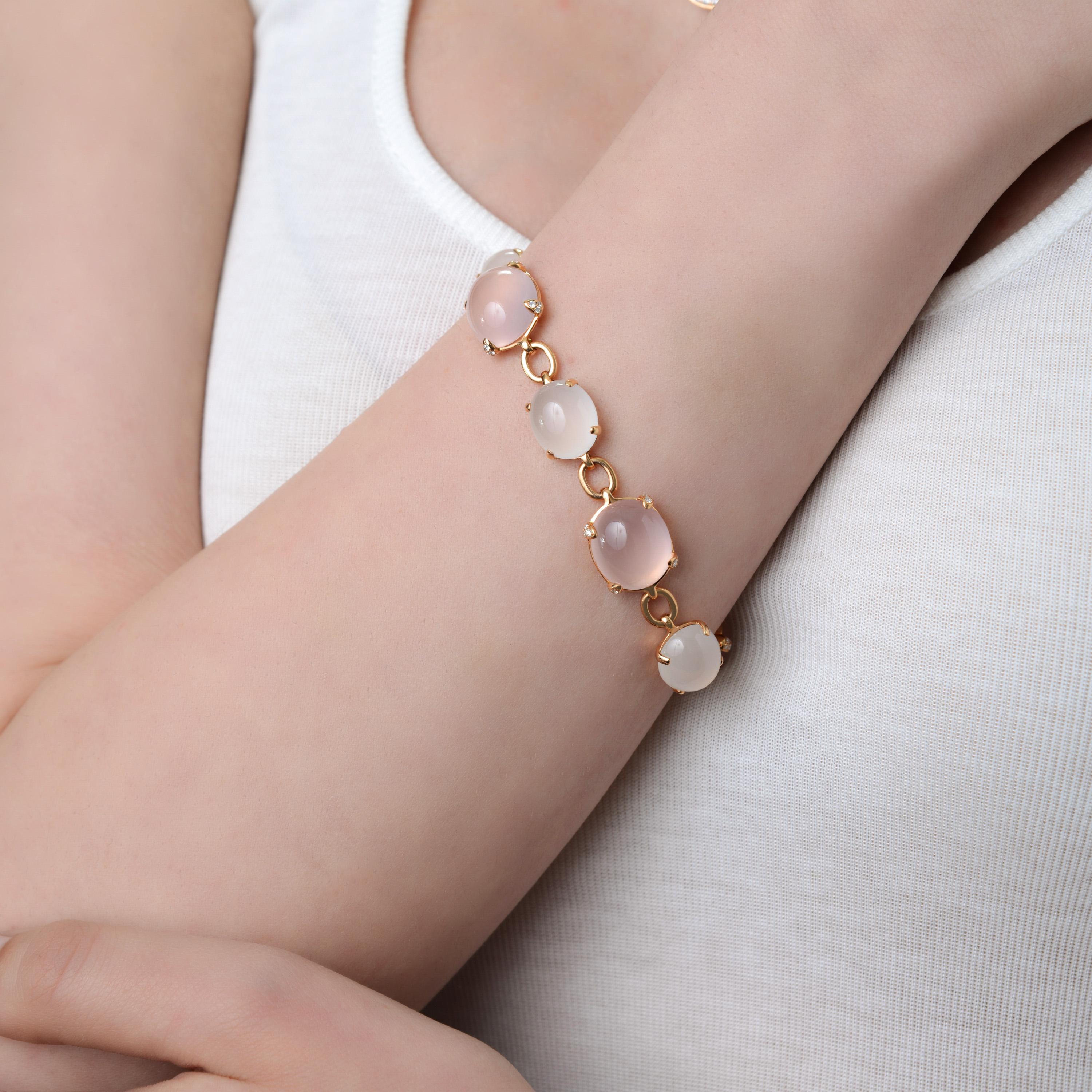 Bucherer 18k rose gold link bracelet features 0.29ct. tw. brilliant cut diamonds with 28.54ct. tw. white quartz and 38.95ct. tw. rose quartz. the bracelet thickness is 9mm. the length is 7