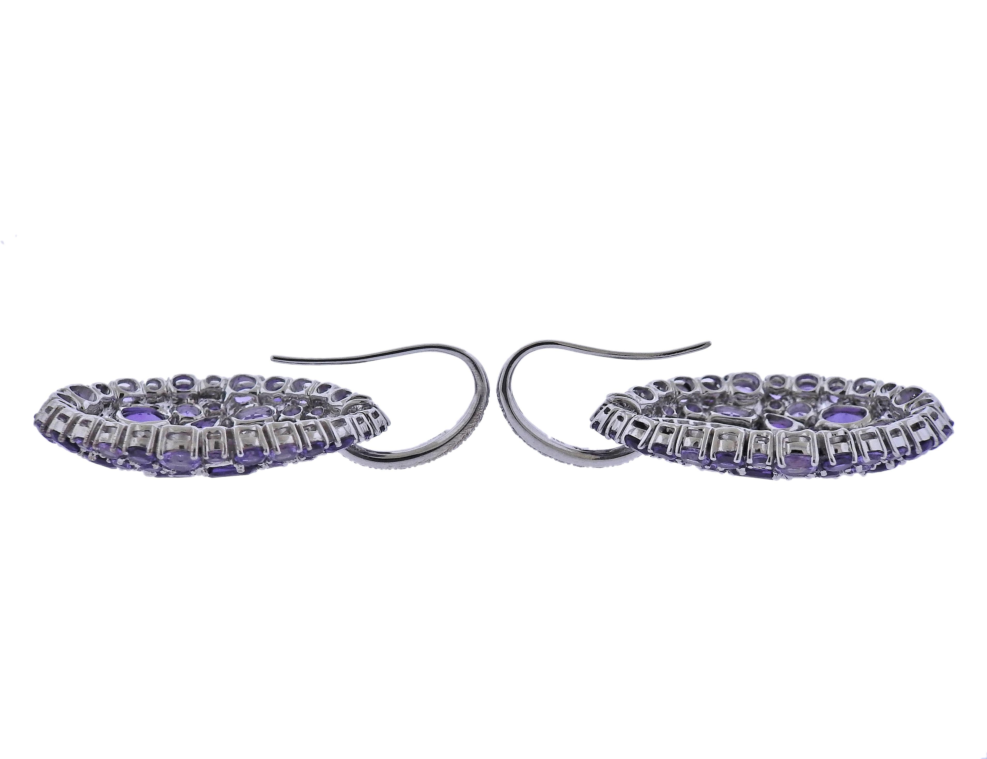 Brand new with tag Bucherer earrings in 18k gold, set with 0.73ctw VS/H diamond and 8.97ctw in amethyst. Retail $7100. Comes with box. Earrings are 42mm x 25mm. Weight - 17.3 grams. Marked: CB 750.
