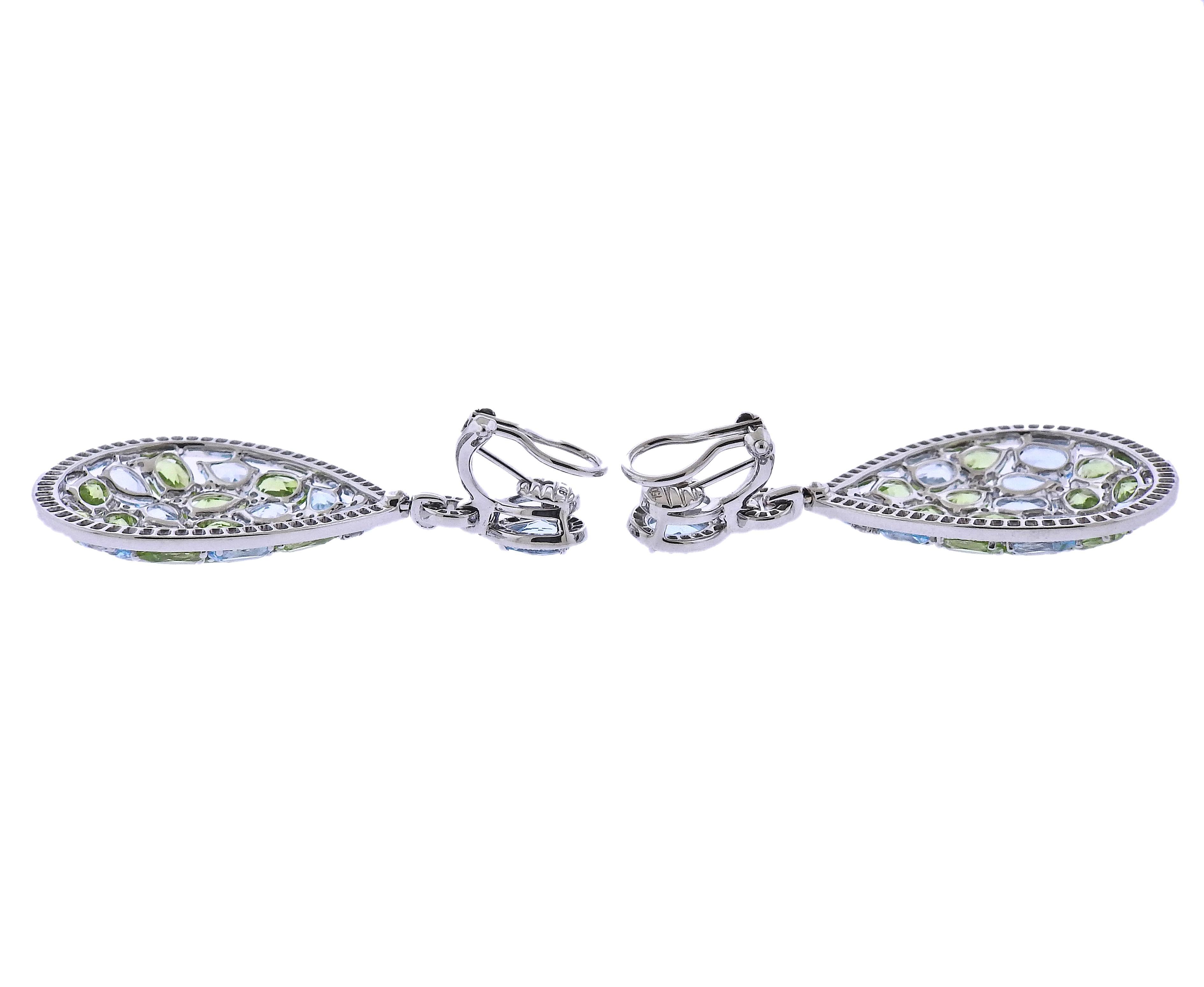Brand new with tag Bucherer earrings, in 18k gold, with  2.04ctw VS/GH diamonds, 8.49ctw peridot and 9.83ctw topaz.  Retail $14750. Comes with box.  Earrings Measure - 51mm long and 28mm at the widest points, weight 24.8 grams. Marked: CB 750.