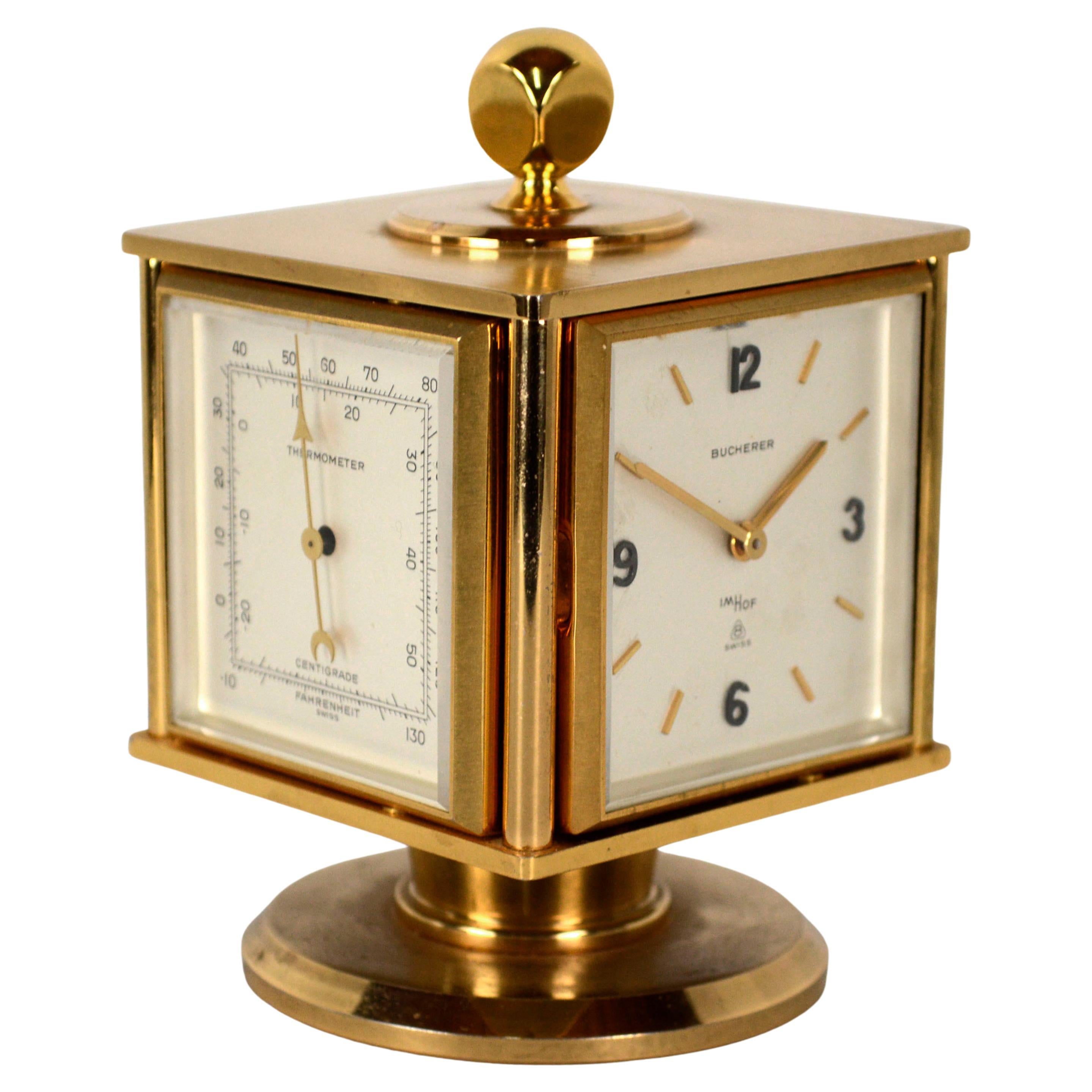 A wonderful Gold toned, brass weather station, 15 Jewel lever escapement, (Lever escapement is used in an accurate pocket watch) 8 day desk clock by Swiss clock makers Bucherer and Imhof. Four instruments are combined in this sleek and compact cube