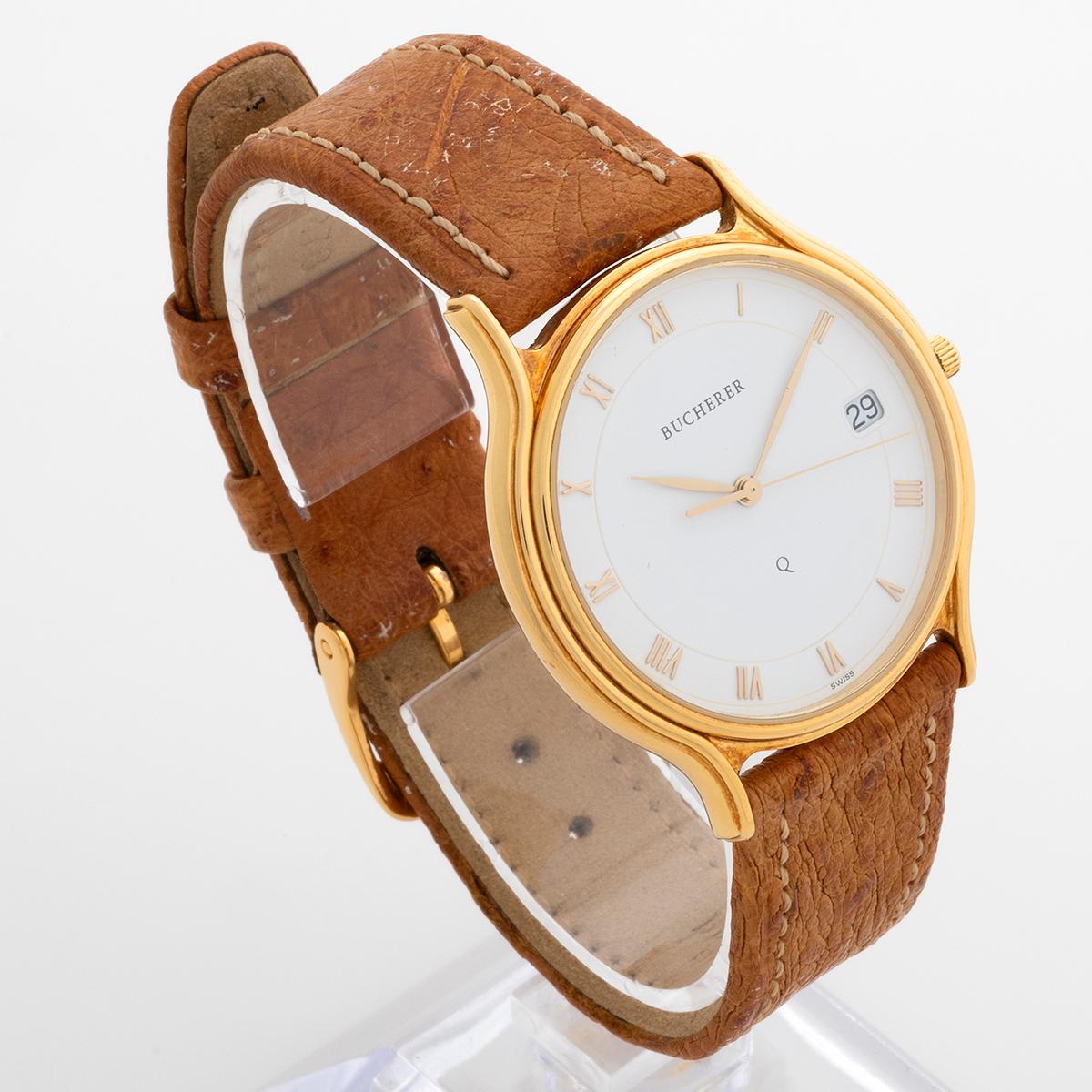 A beautiful neo-vintage dress watch, our Bucherer 255.107 features a 18k yellow gold 35mm case, with white dial with Roman numerals, quartz movement, tan leather strap and gold tone tang buckle. Presented in superb condition, almost new old stock ,