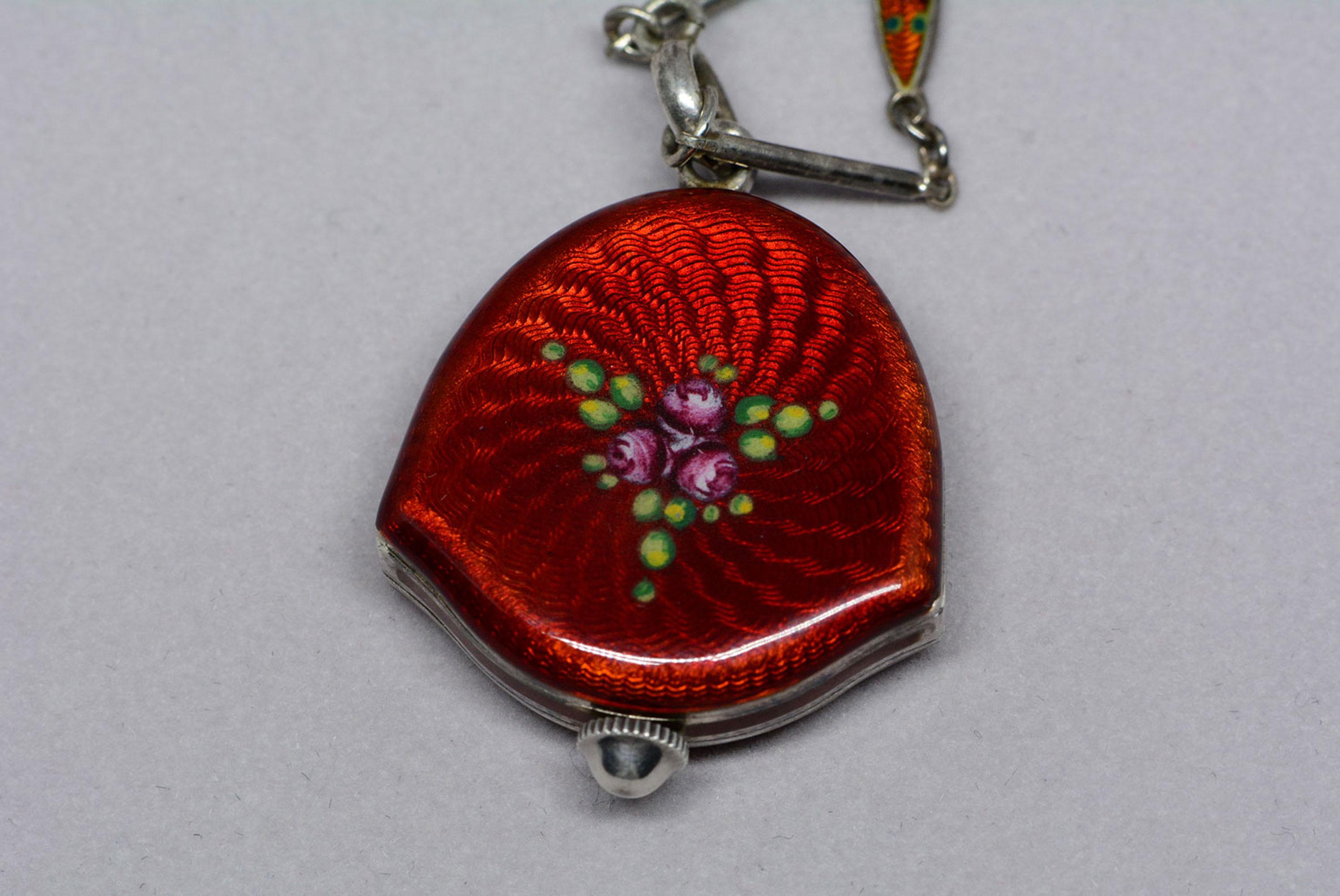 This Bucherer watch pendant is made from sterling silver and has lovely enamelling in a floral motif on the watch case and on the links connected to the chain.
This all would have been applied by hand and it's something you don't see nowadays due to
