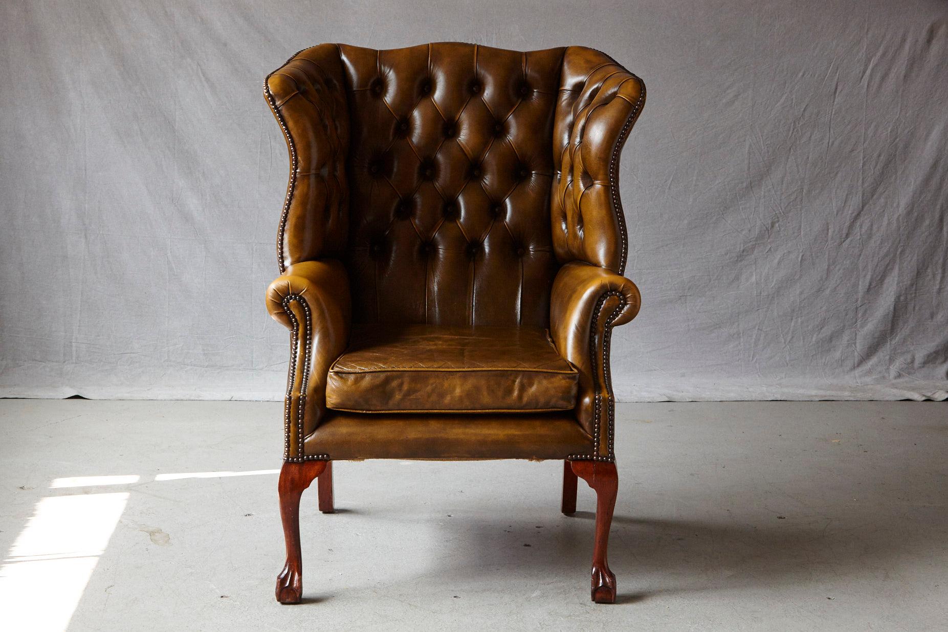 Very comfortable wingback chair upholstered in Buckingham Walnut burnished leather with nailhead trim and clawfeet legs in the front, by Hancock & Moore.
Seat height 20.5 inches, seat depth 22.5 inches.

Buckingham is an old world form of