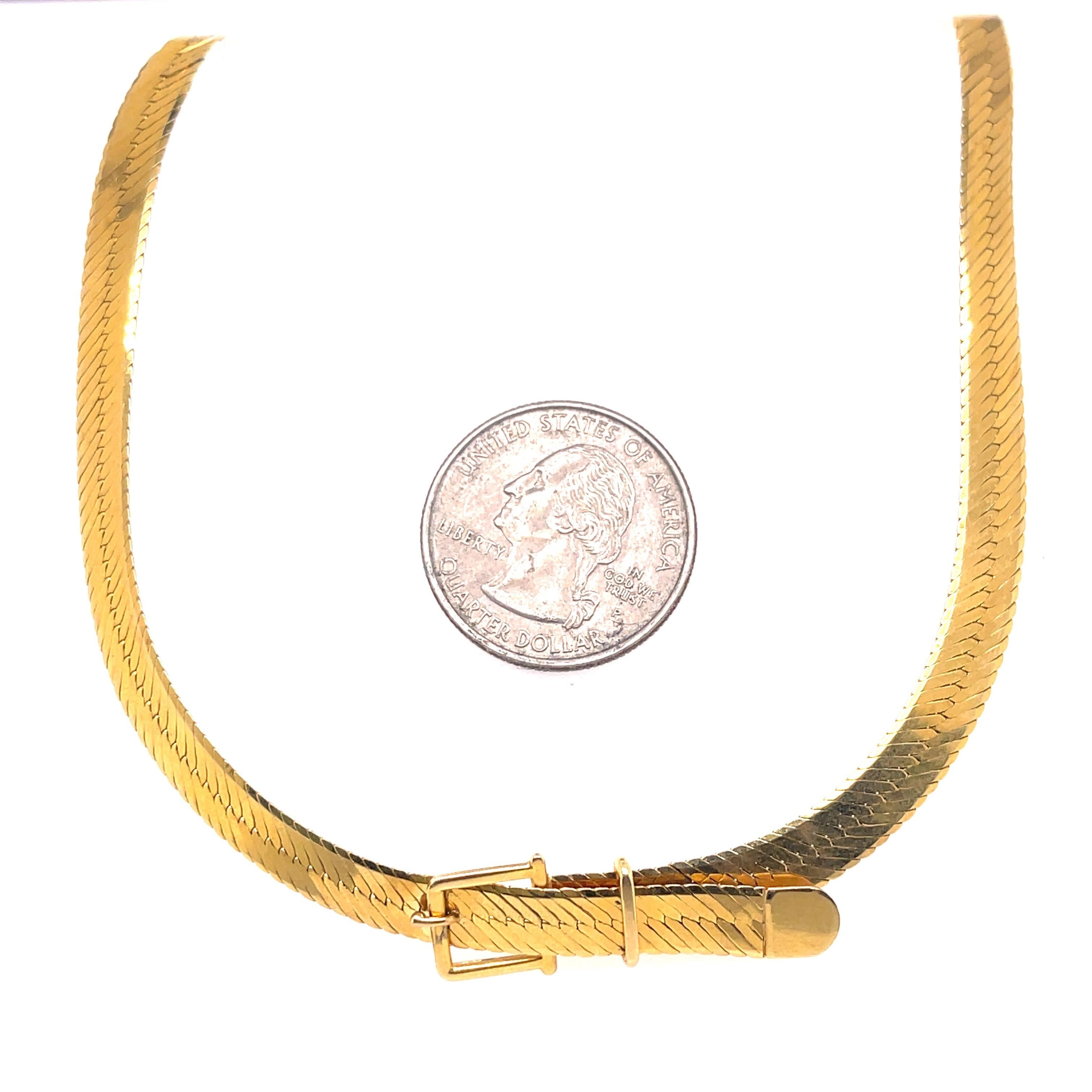 Vintage 14 karat yellow gold necklace featuring a herringbone chain with a center buckle motif. Made in Italy
Lobster Clasp