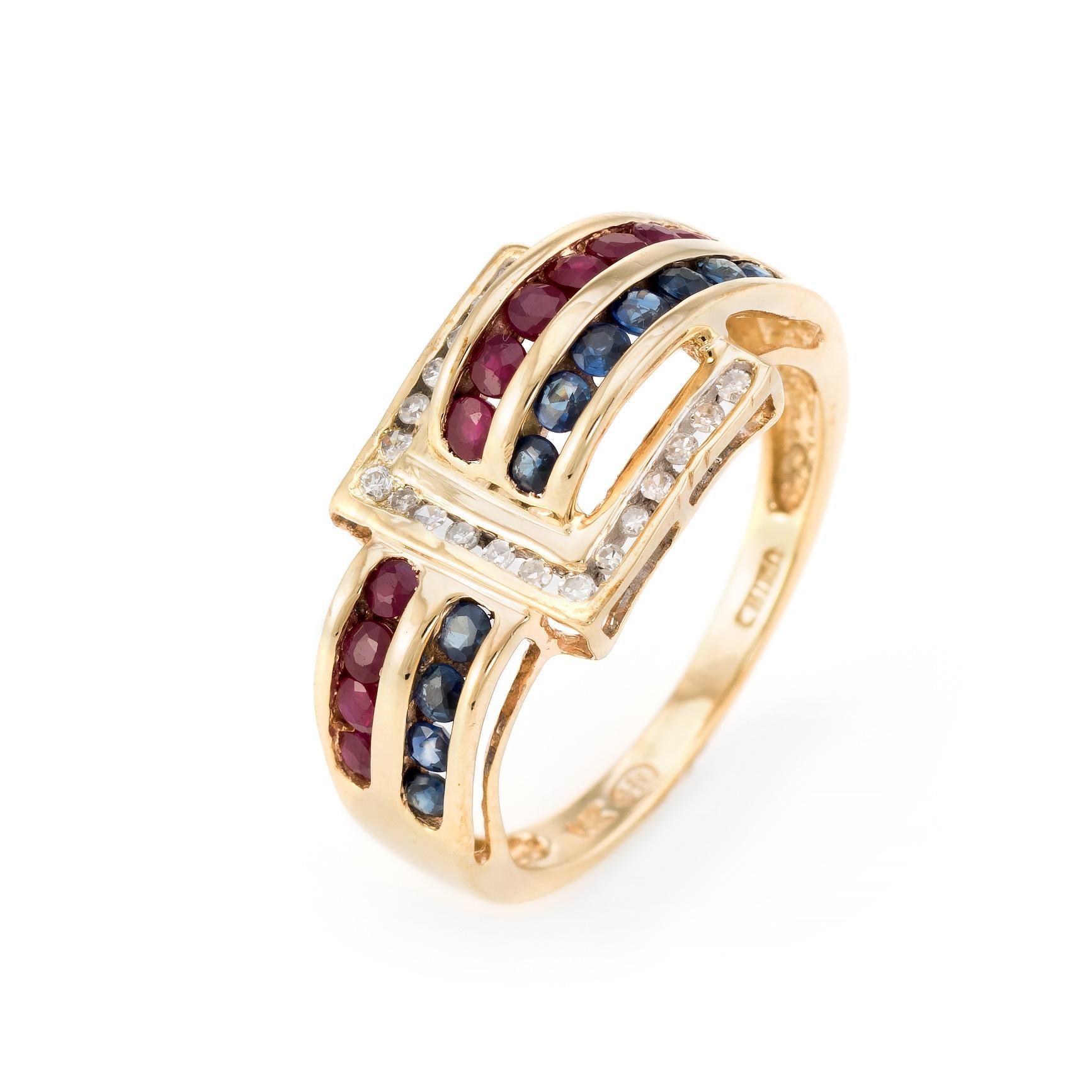 Elegant vintage buckle ring, crafted in 14 karat yellow gold. 

11 faceted round cut sapphire are estimated at 0.02 carats each (0.22 carats total estimated weight), accented with 11 estimated 0.02 carat rubies (0.22 carats total estimated weight).