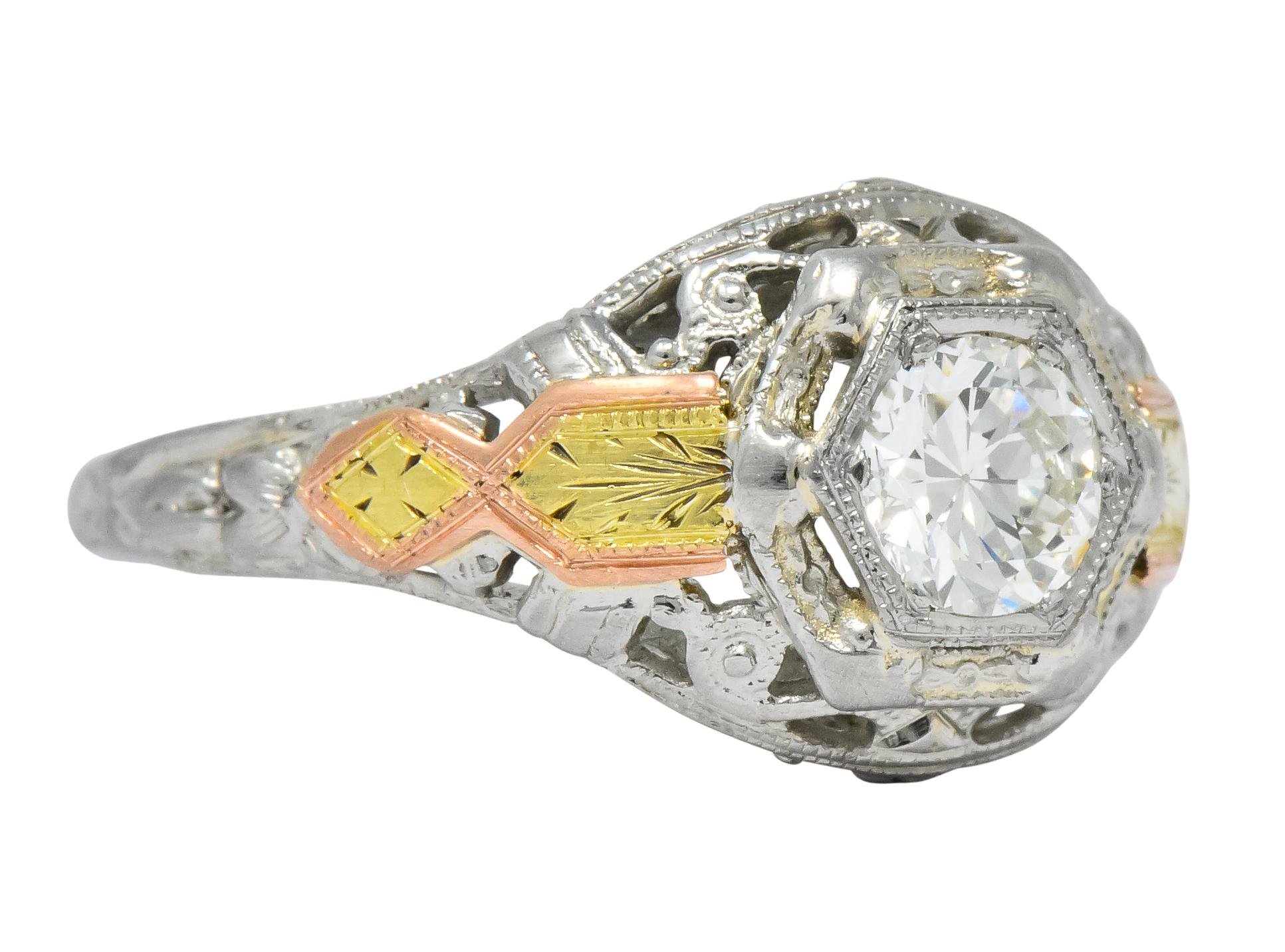 Centering a transitional cut diamond weighing approximately 0.42 carat, I color and VS clarity

Within a 14 karat white gold hexagonal head 

Applied yellow and rose gold accents along with pierced and engraved gold detail

Tested as 14 karat