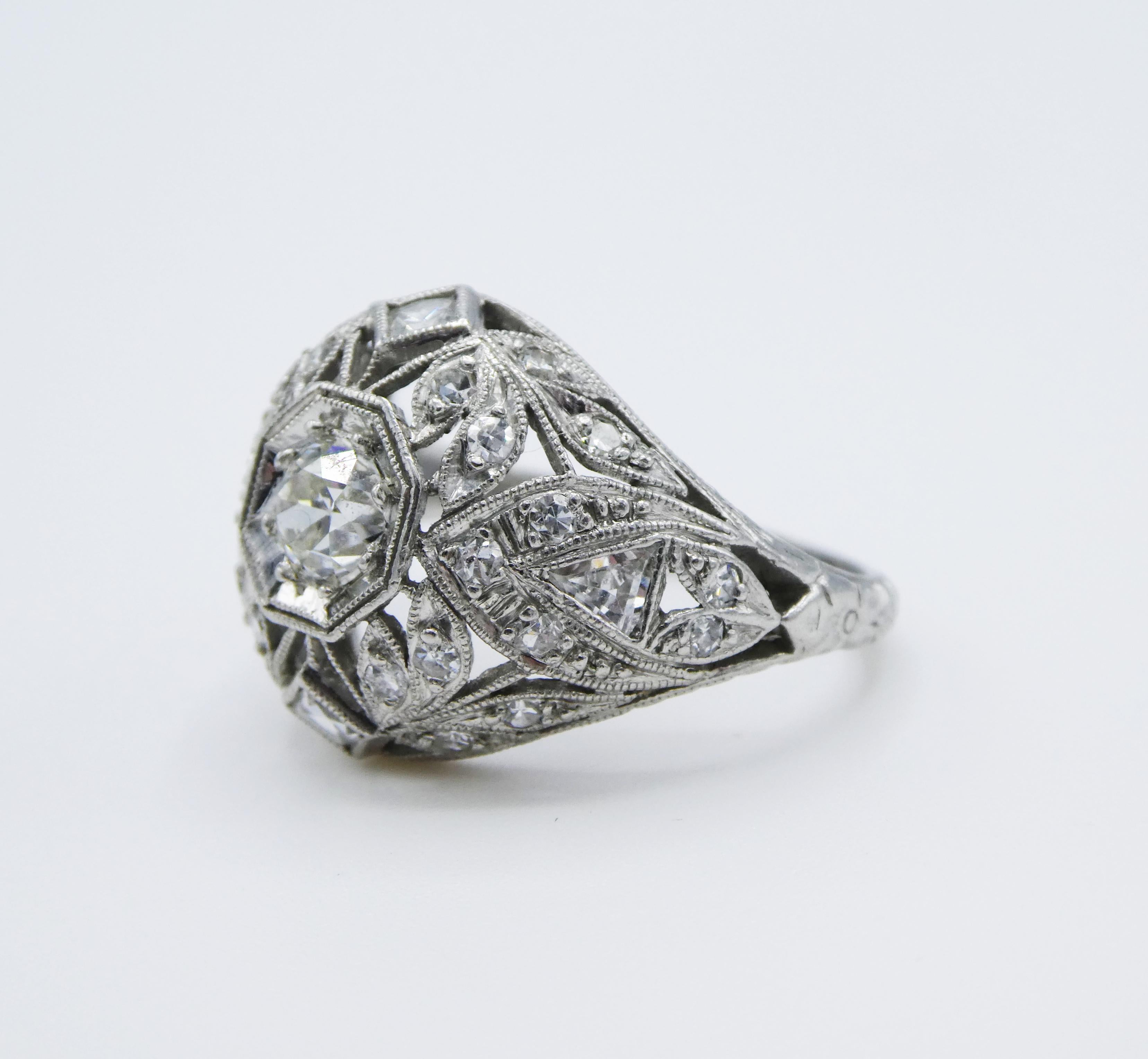 For sale is an original Art Deco Bud & Blossom platinum diamond filigree engraved dome ring. 

Metal: Platinum
Weight: 4.05 grams
One European Cut diamond center stone measuring approx. .25 ct G SI1, 
Side Stones: 26 single cut round diamonds, 2