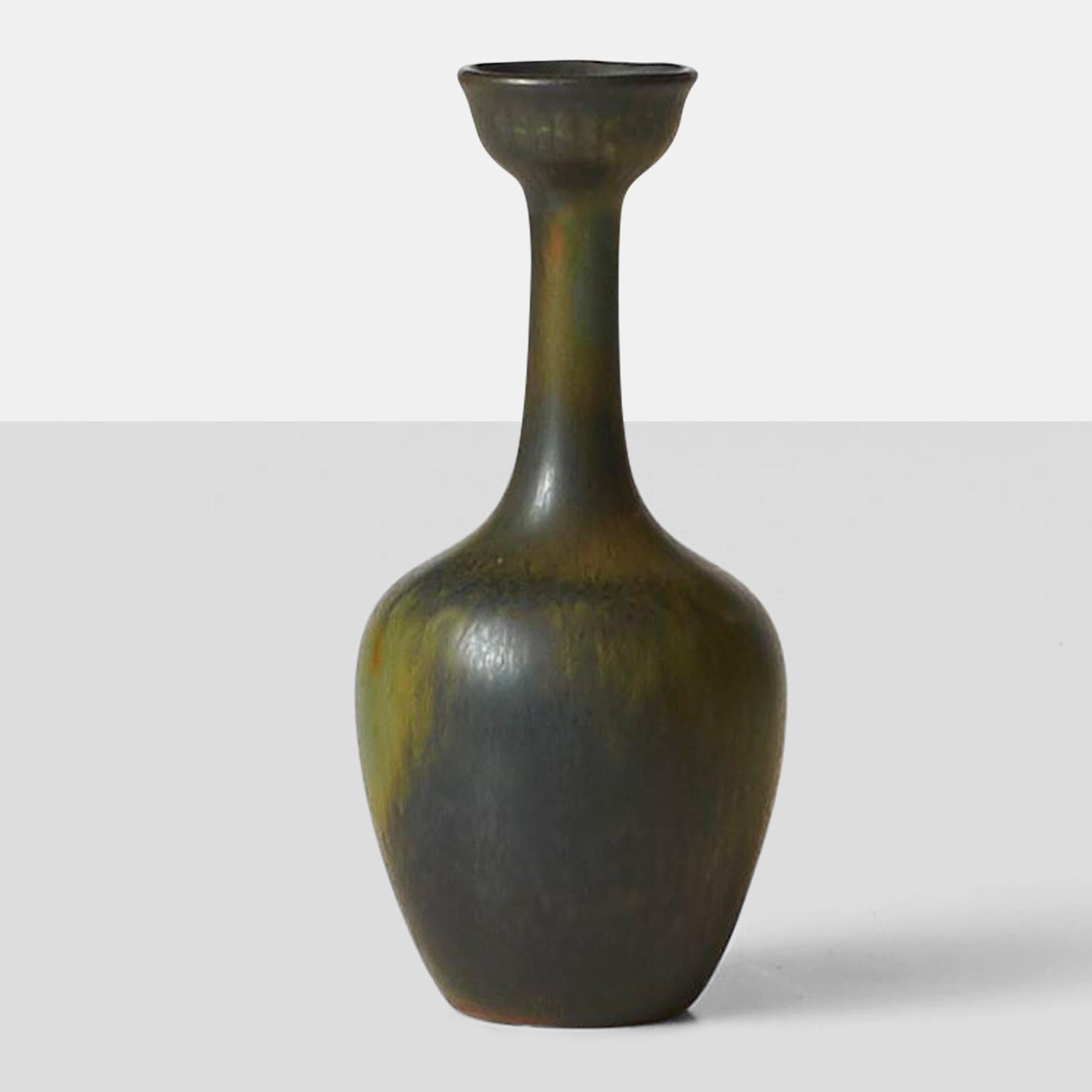 A small bud vase with hare's fur glaze in running colors of blue and green. By Gunnar Nylund for Rorstrand, and marked accordingly.