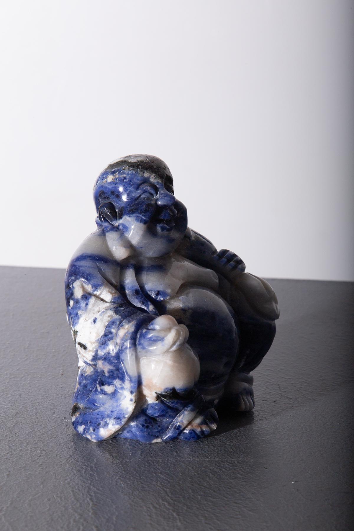 This beautiful Budai sculpture, crafted from blue and white jade, represents the famous 