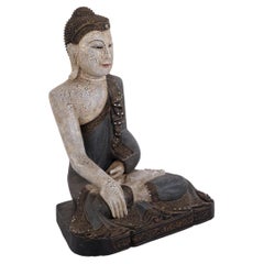 Buddha figure in carved wood with light and blue-toned patina from Thailand 1920